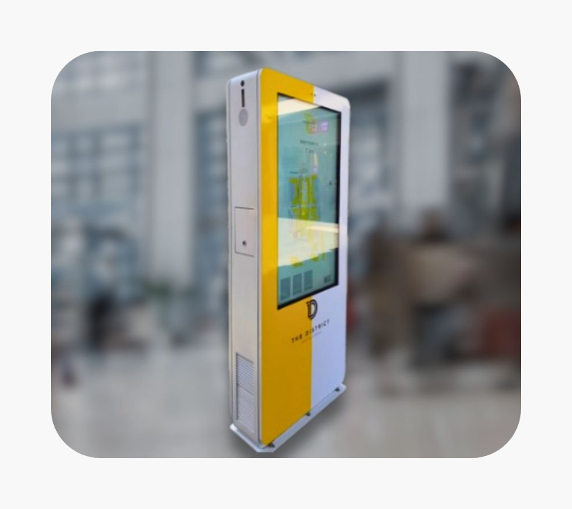 Tall digital wayfinding kiosk with a yellow and white design displaying a shopping center map and directory.