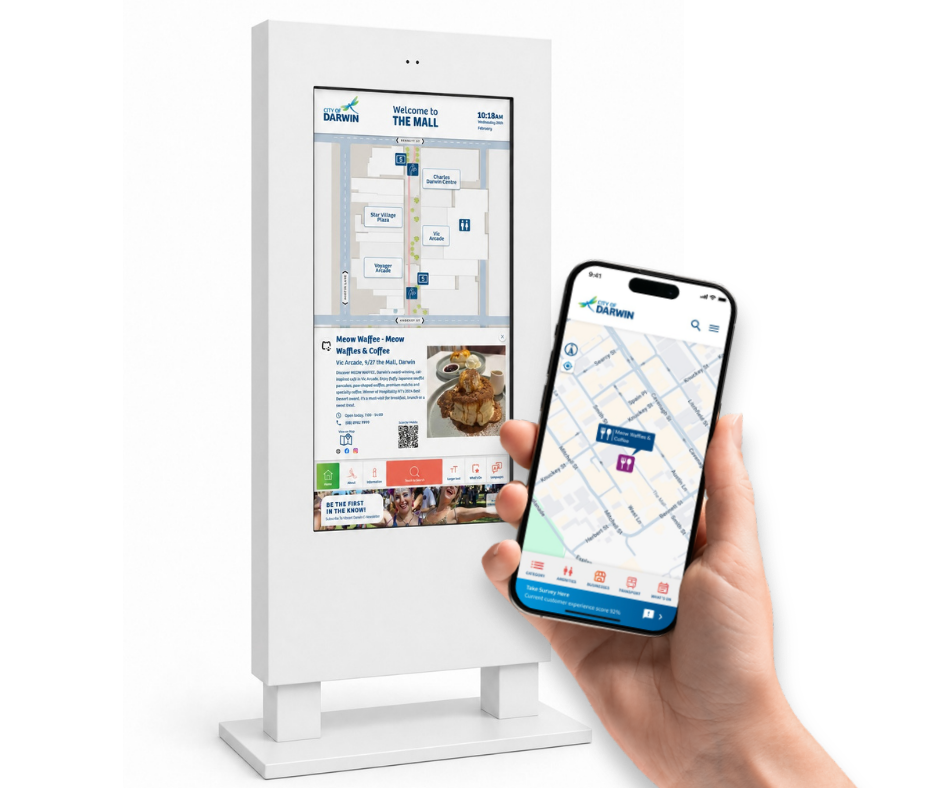 Interactive digital wayfinding kiosk displaying a mall map and business details for Meow Waffee in the City of Darwin, alongside a hand holding a smartphone showing a corresponding digital map with the Meow Waffee location highlighted.