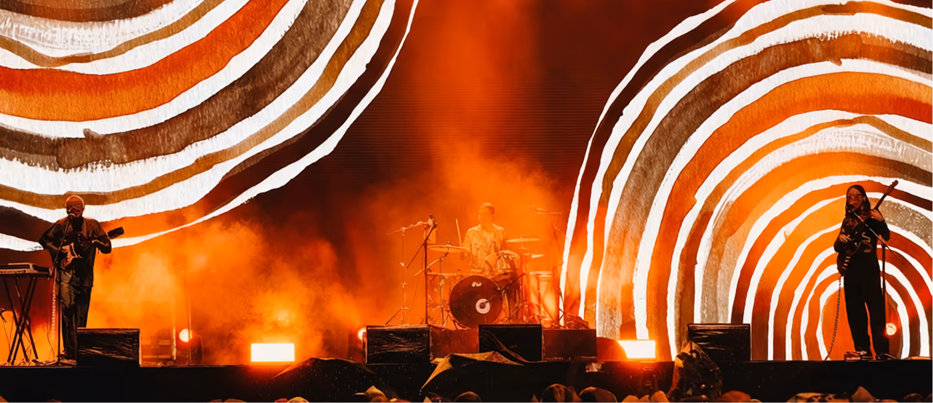 Mahal - Glass Beams performing on stage with circle artwork on background.