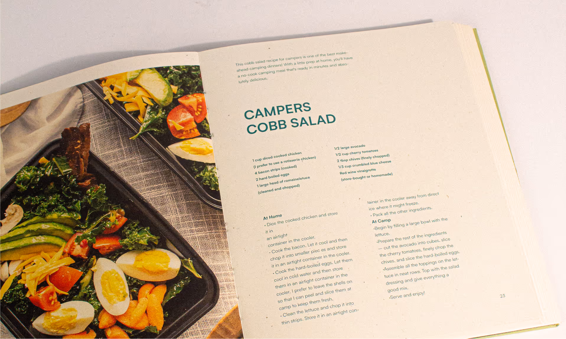 Open cookbook showing a Camper's Cobb Salad recipe with a salad.