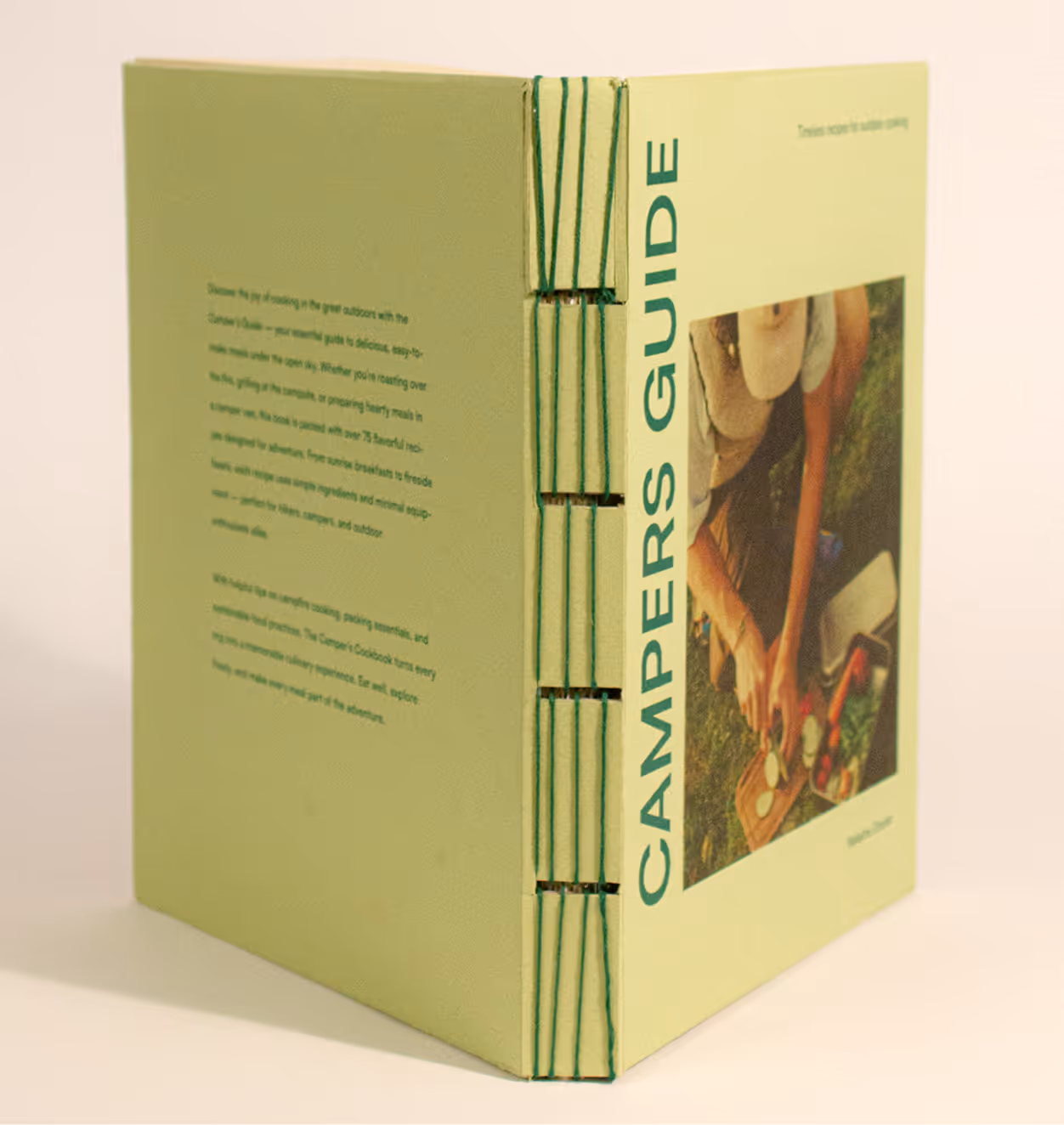 Green book titled 'Campers Guide' with visible stitching on spine.