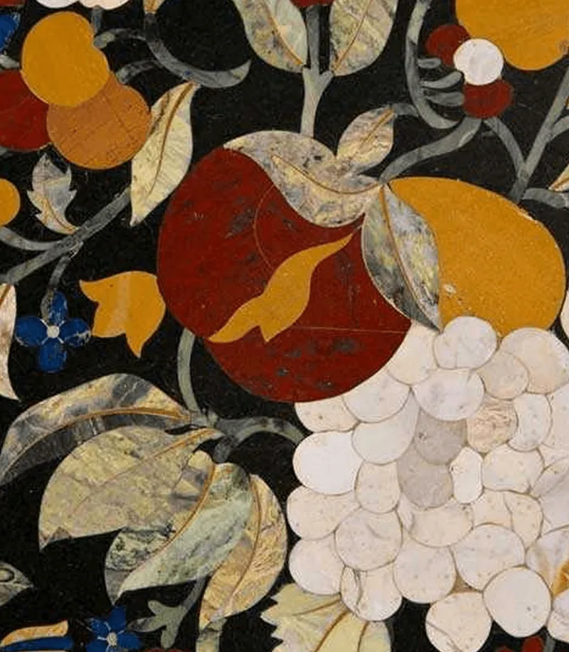 Close-up of Pietra Dura inlay showing a pomegranate and grapes in coloured stones on black marble