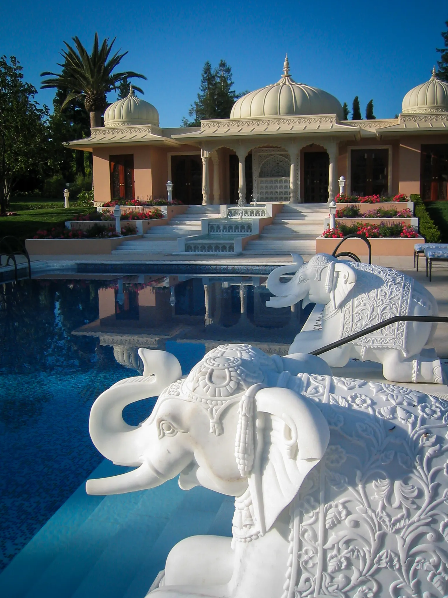 Pair of carved white marble elephants beside the pool with domed pavilions behind, The Los Altos Hills Estate, California