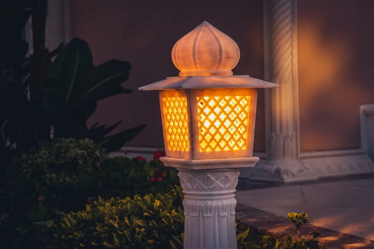 Hand-carved marble garden lantern with a domed top glowing at dusk, The Los Altos Hills Estate, California