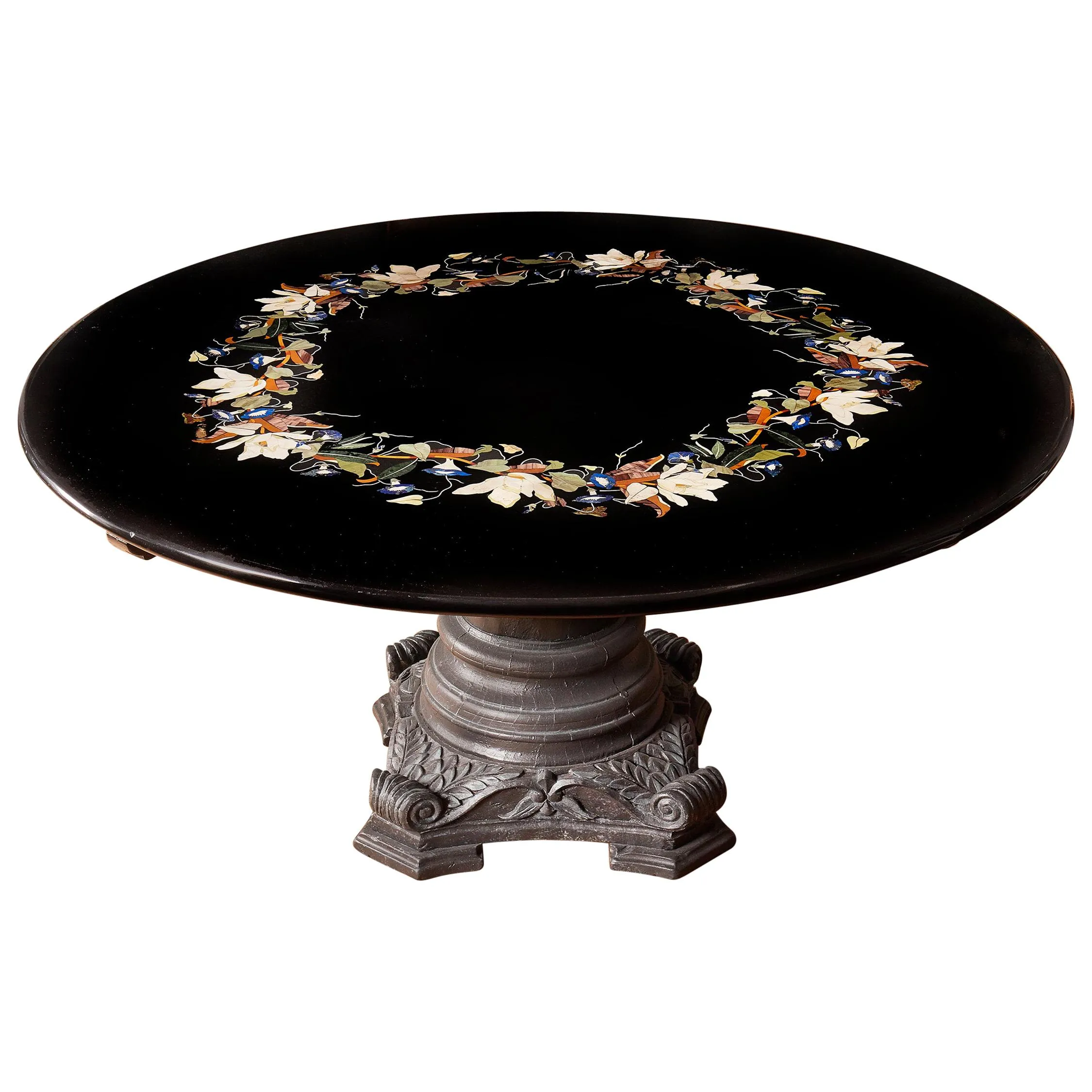 Round black marble table with a pietra dura floral inlay border on a carved stone pedestal