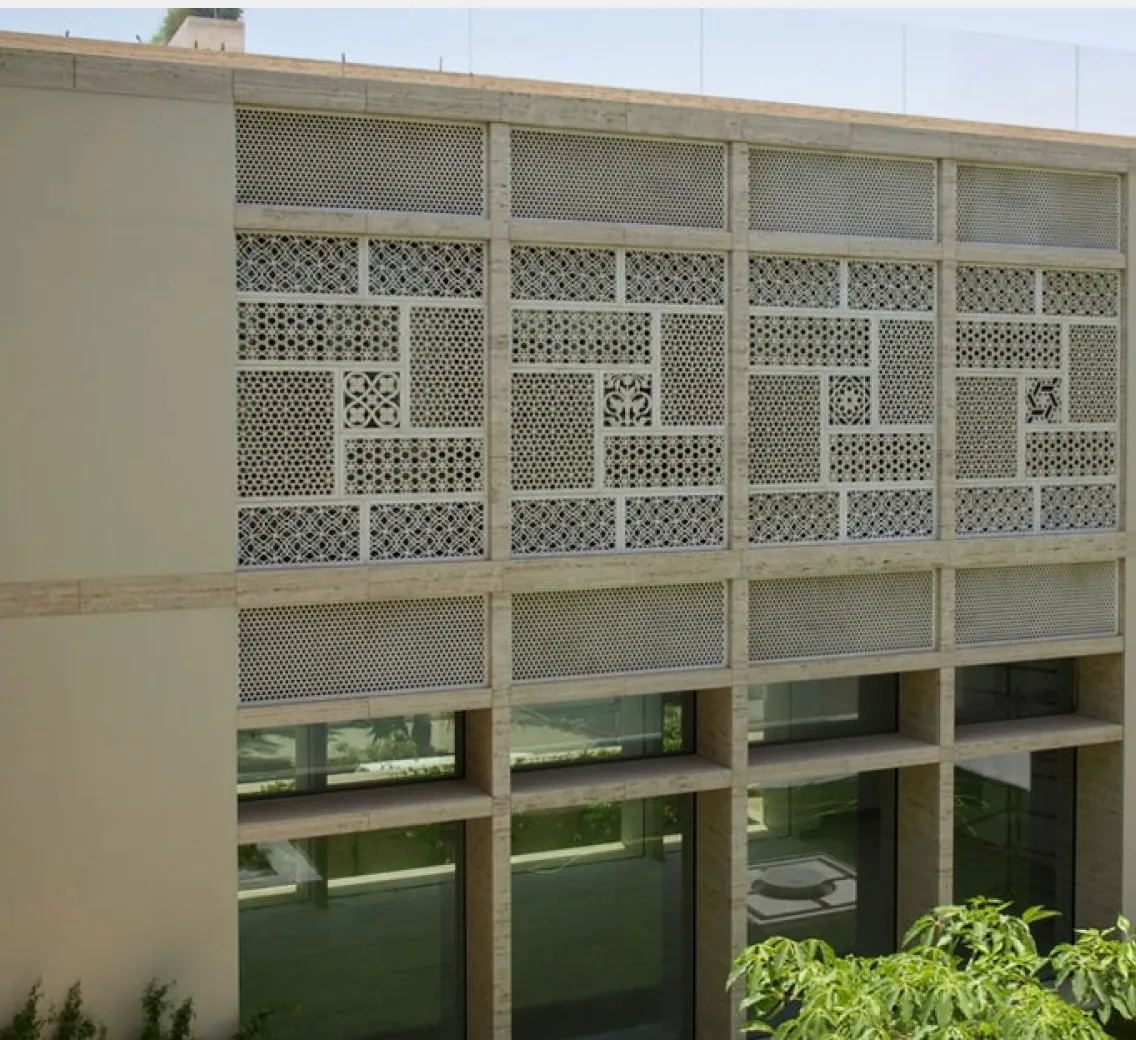 Carved stone mashrabiya panels wrapping the upper facade of the Elite Residence, Kuwait