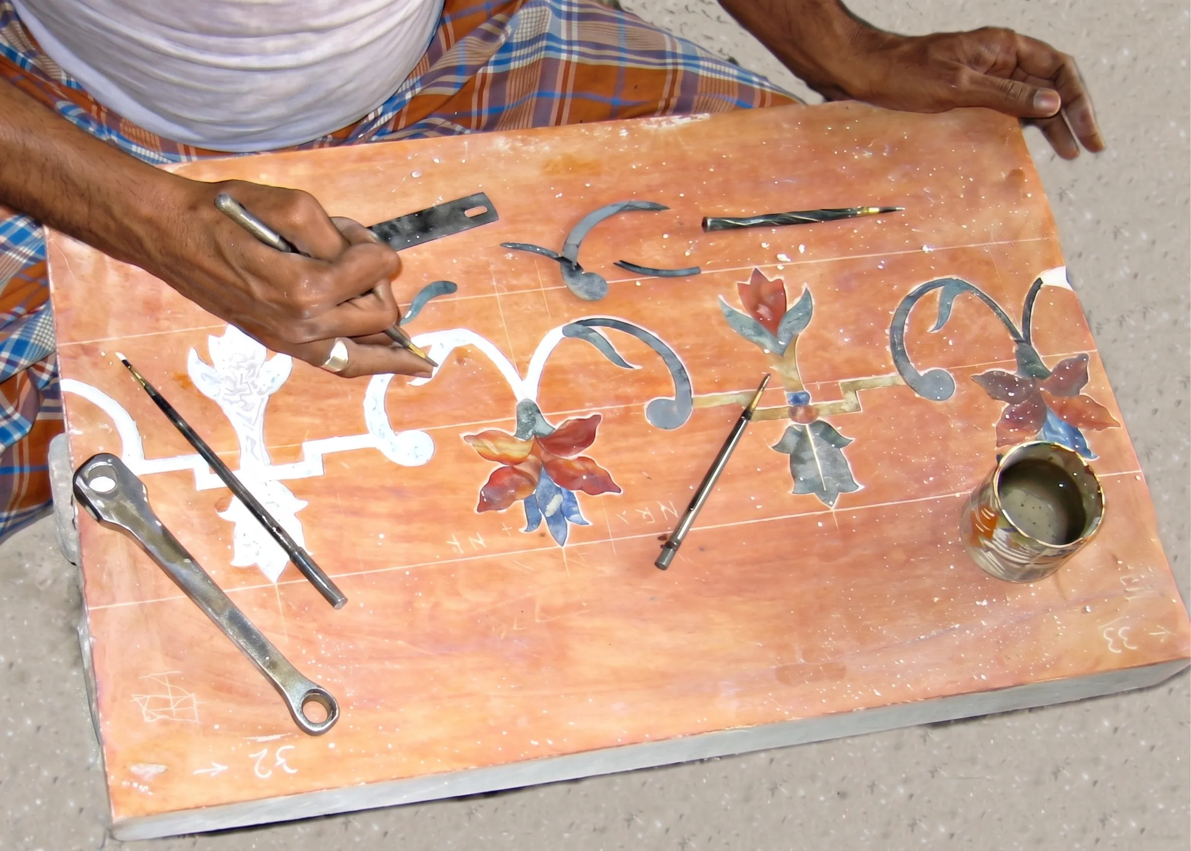 Artisan aligning semi-precious stone petals by hand during pietra dura assembly for The Los Altos Hills Estate