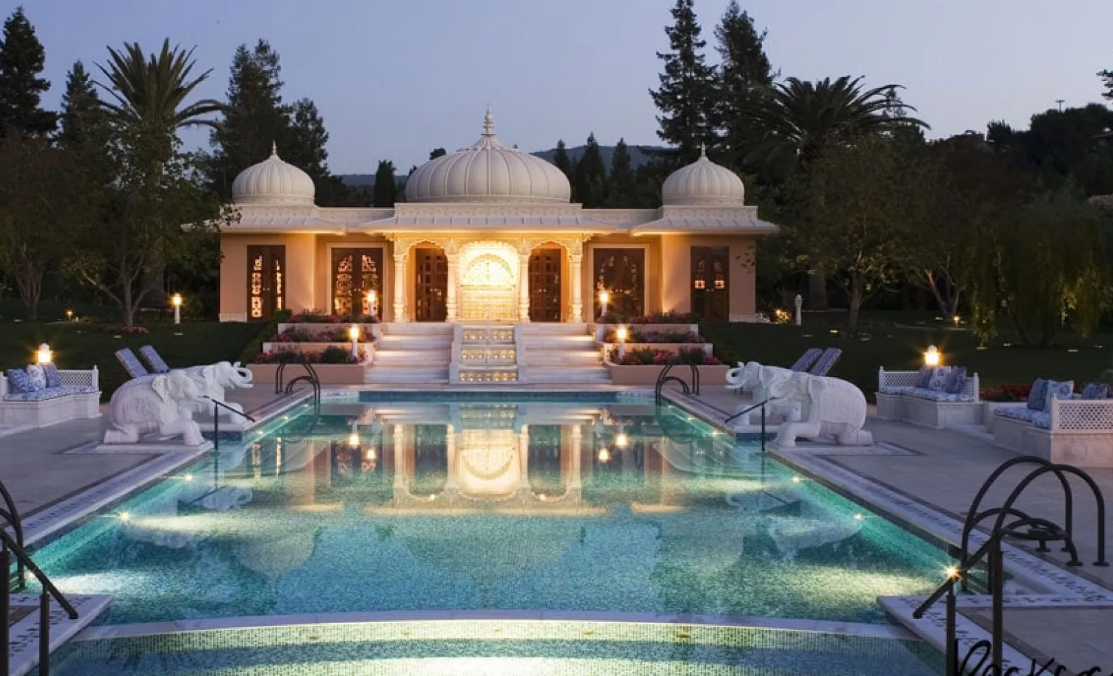Illuminated pool and domed Mughal-style pavilion at dusk, The Los Altos Hills Estate, California