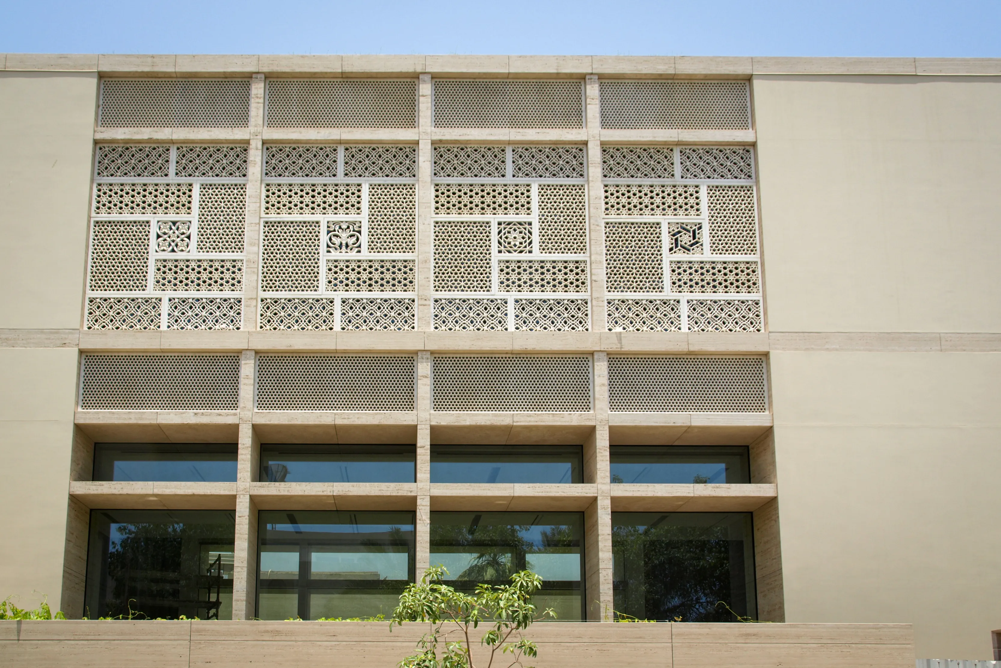Front elevation of the Elite Residence, Kuwait, with a band of geometric stone jali panels above the ground-floor windows