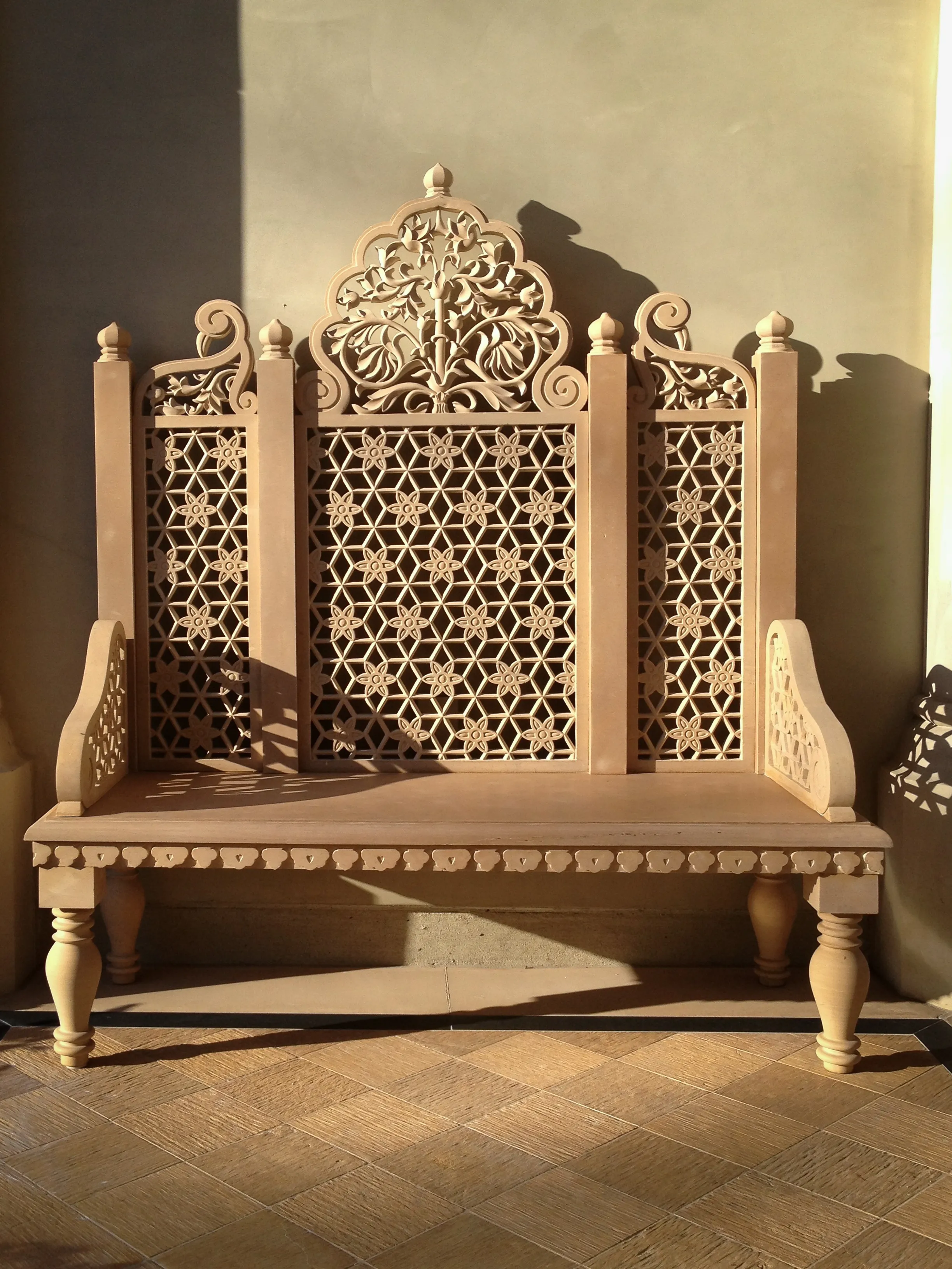 Carved sandstone bench with a high jali backrest and Mughal-style crest, Desert Sanctuary, Palm Springs