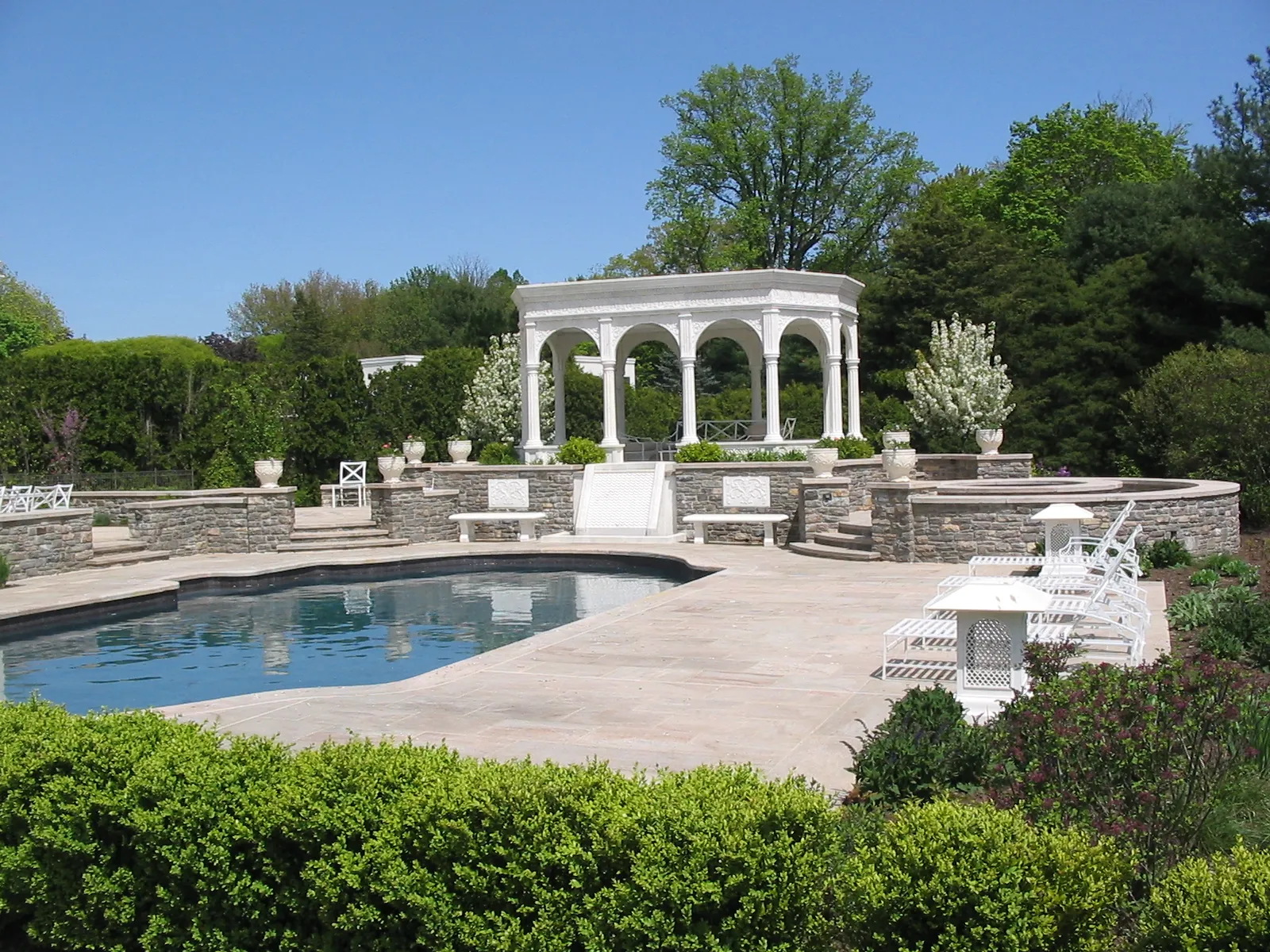 Swimming pool and stone terrace with the white marble pavilion beyond, Westport, Connecticut estate