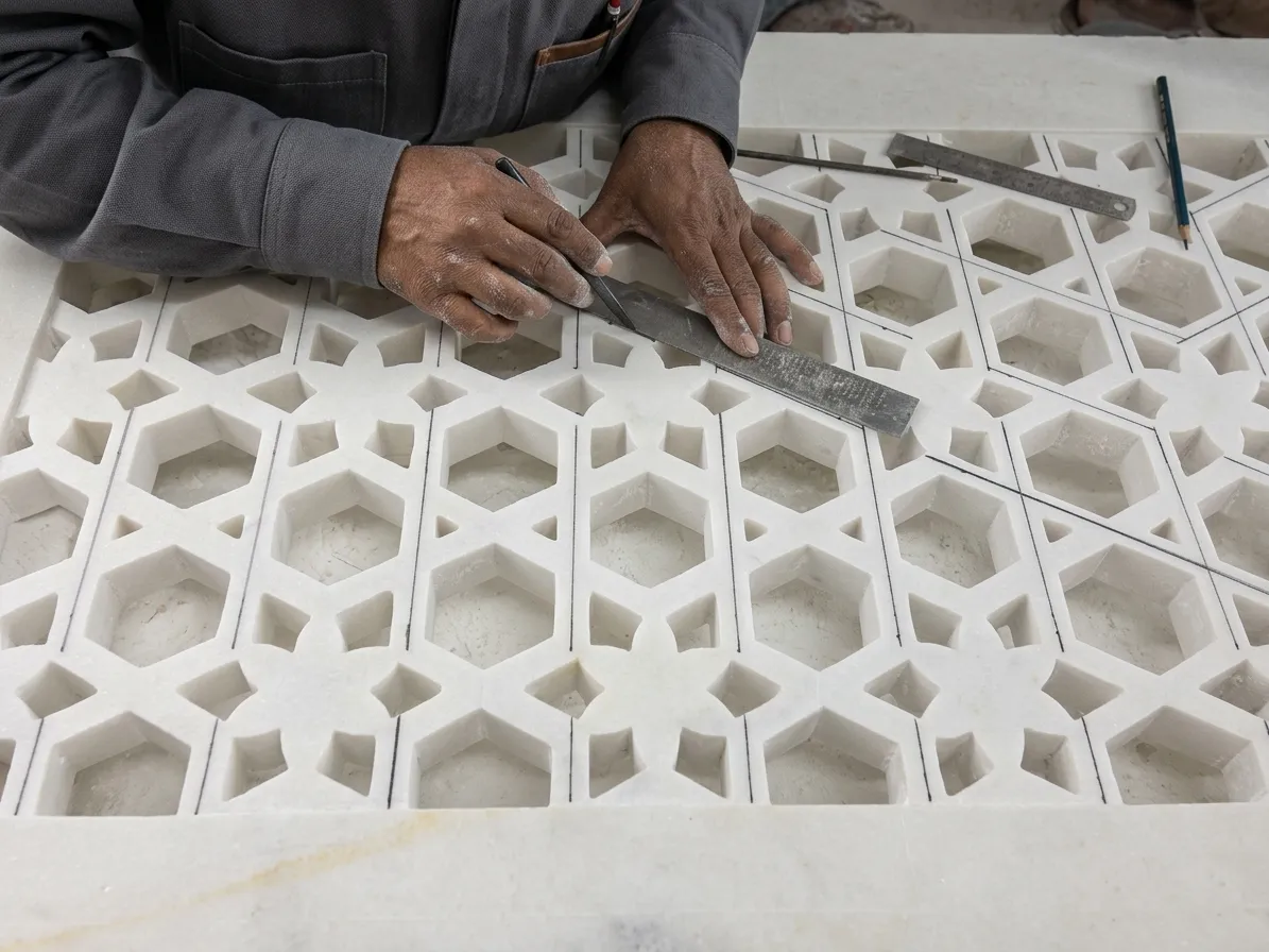 Craftsman measuring a hexagonal-pattern marble jali panel with a steel rule for the Elite Residence, Kuwait