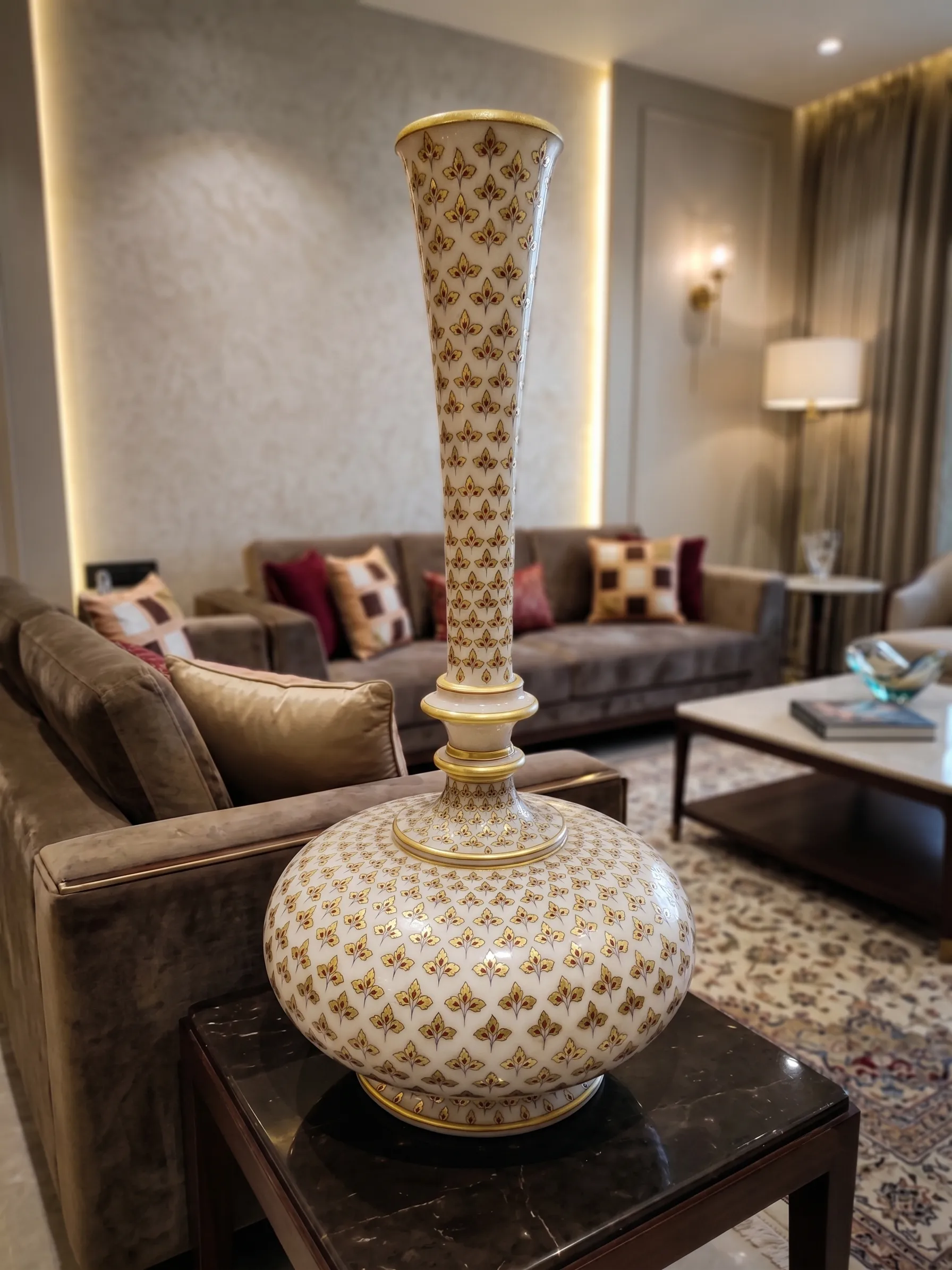 The Imperial Gilded Vessel on a side table in a living room with a sofa and lamp