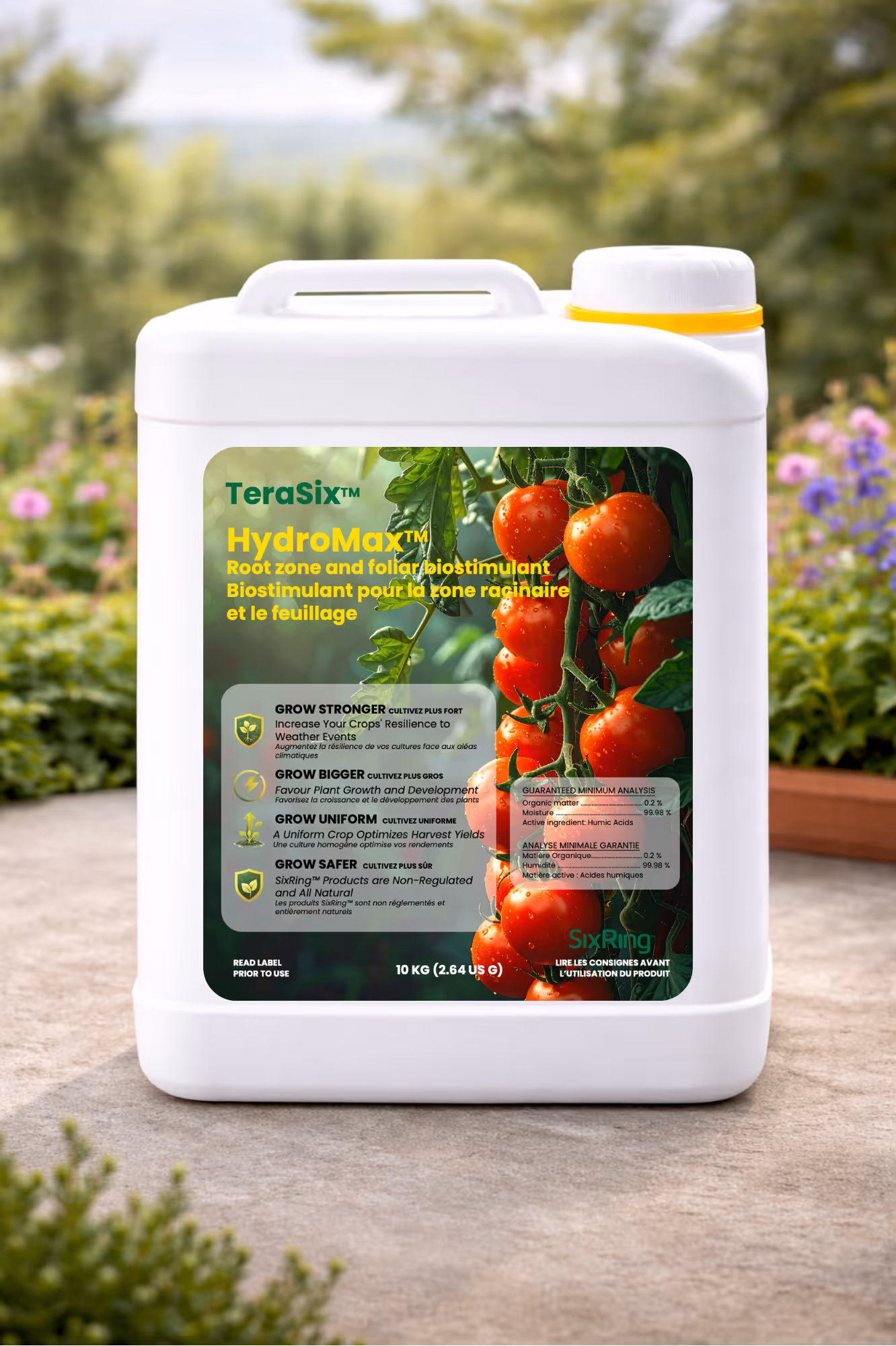 White container of TeraSix HydroMax biostimulant with tomatoes on label outdoors.