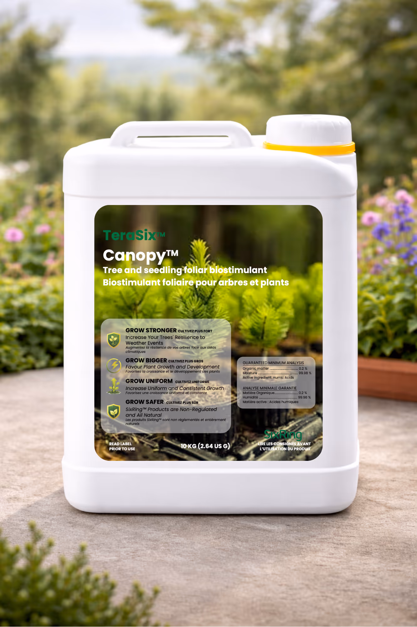 White container of Canopy tree and seedling foliar biostimulant with green plants in background.