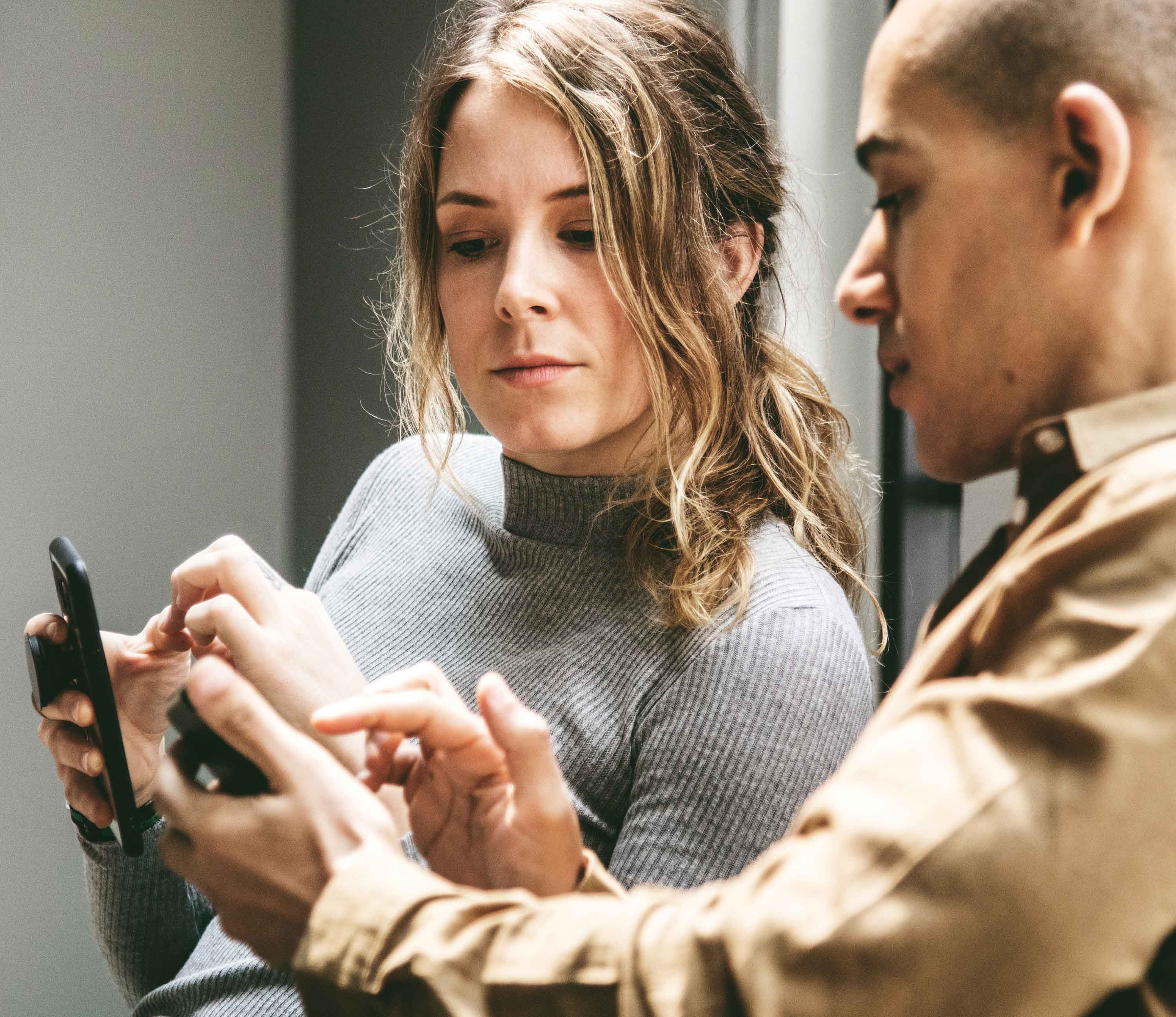 A man and a women coordinating with their phones|Elderly persons hands crossed