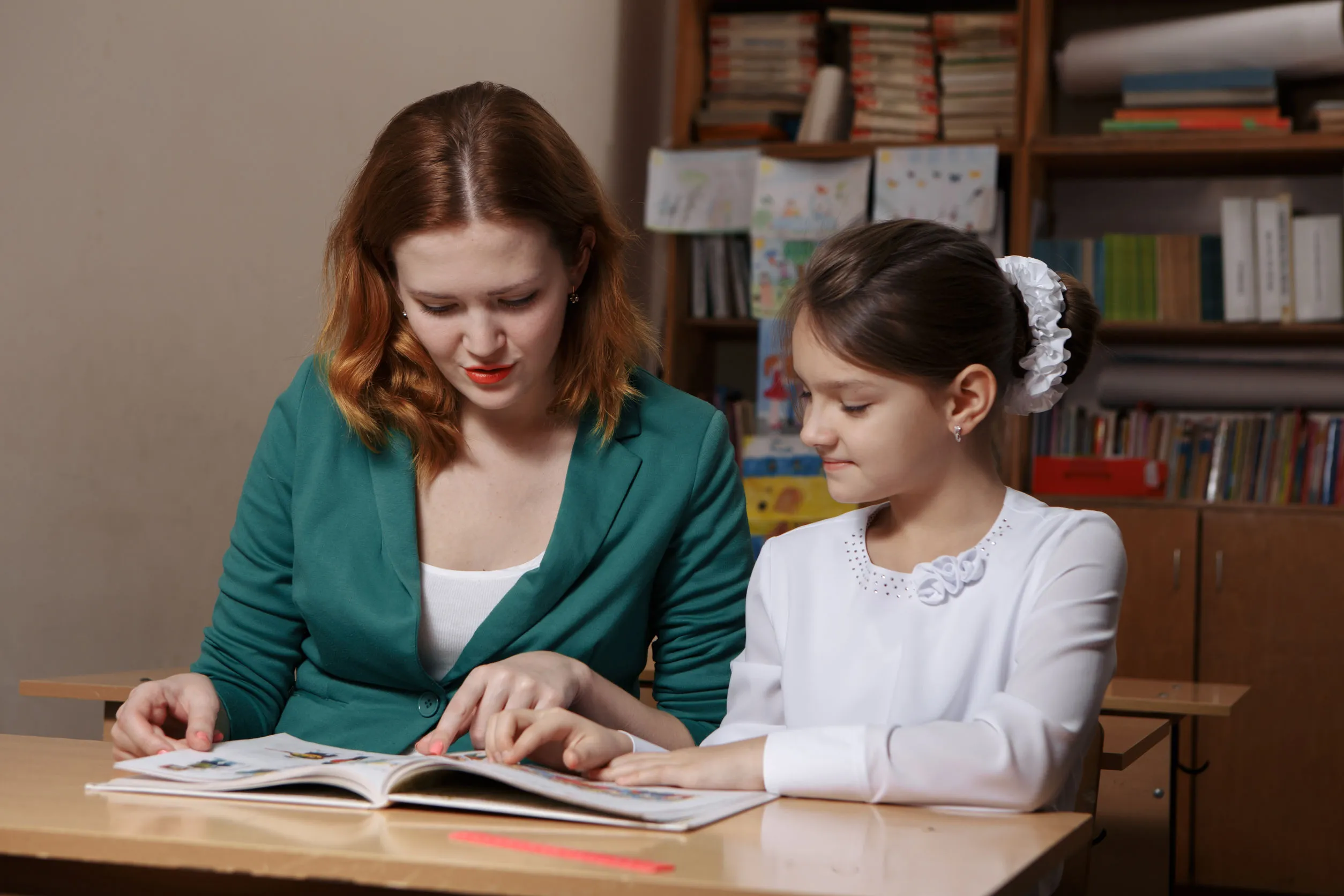 Speech pathologist woman is working with a little girl