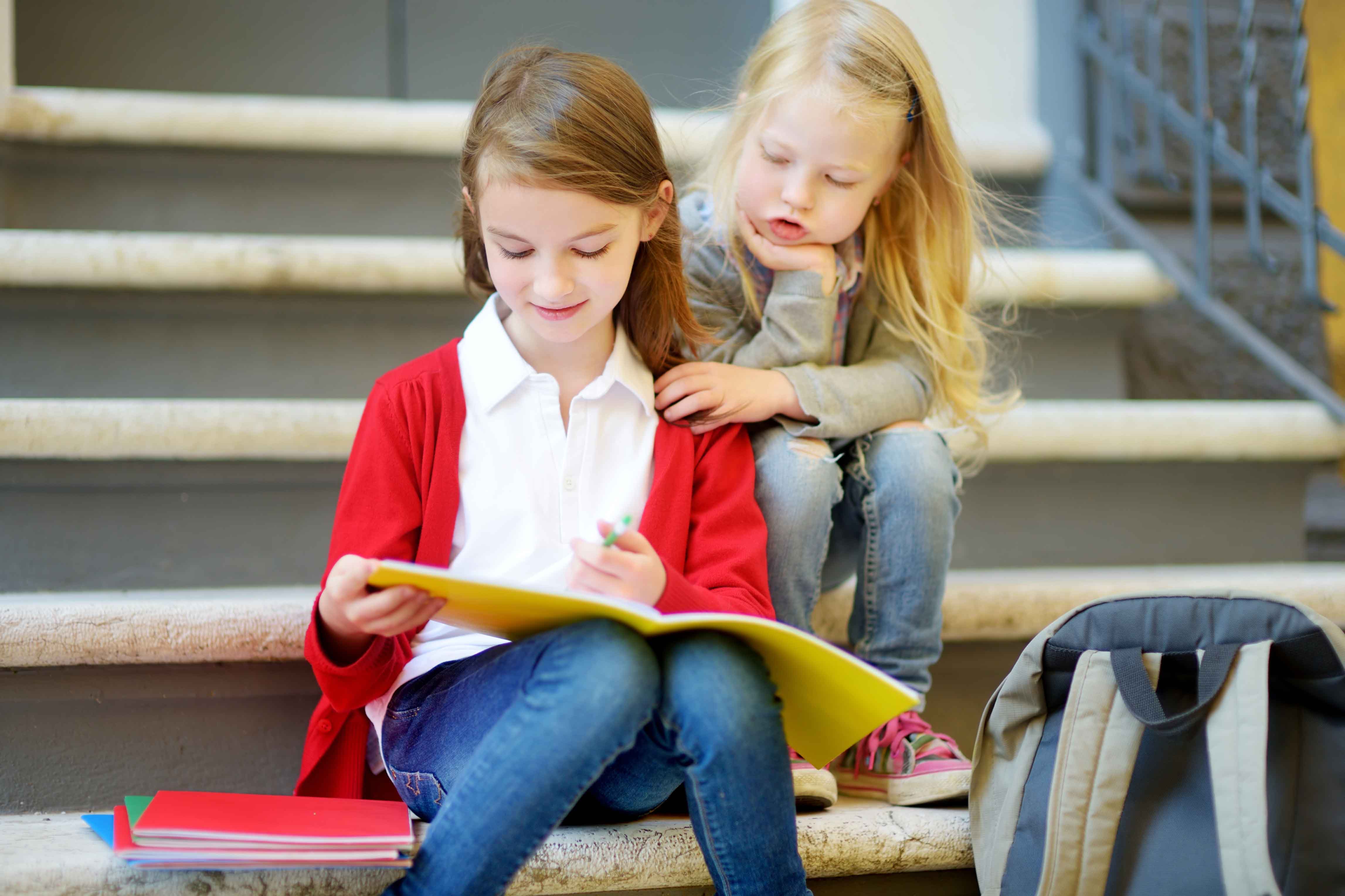 Children helping one another with reading