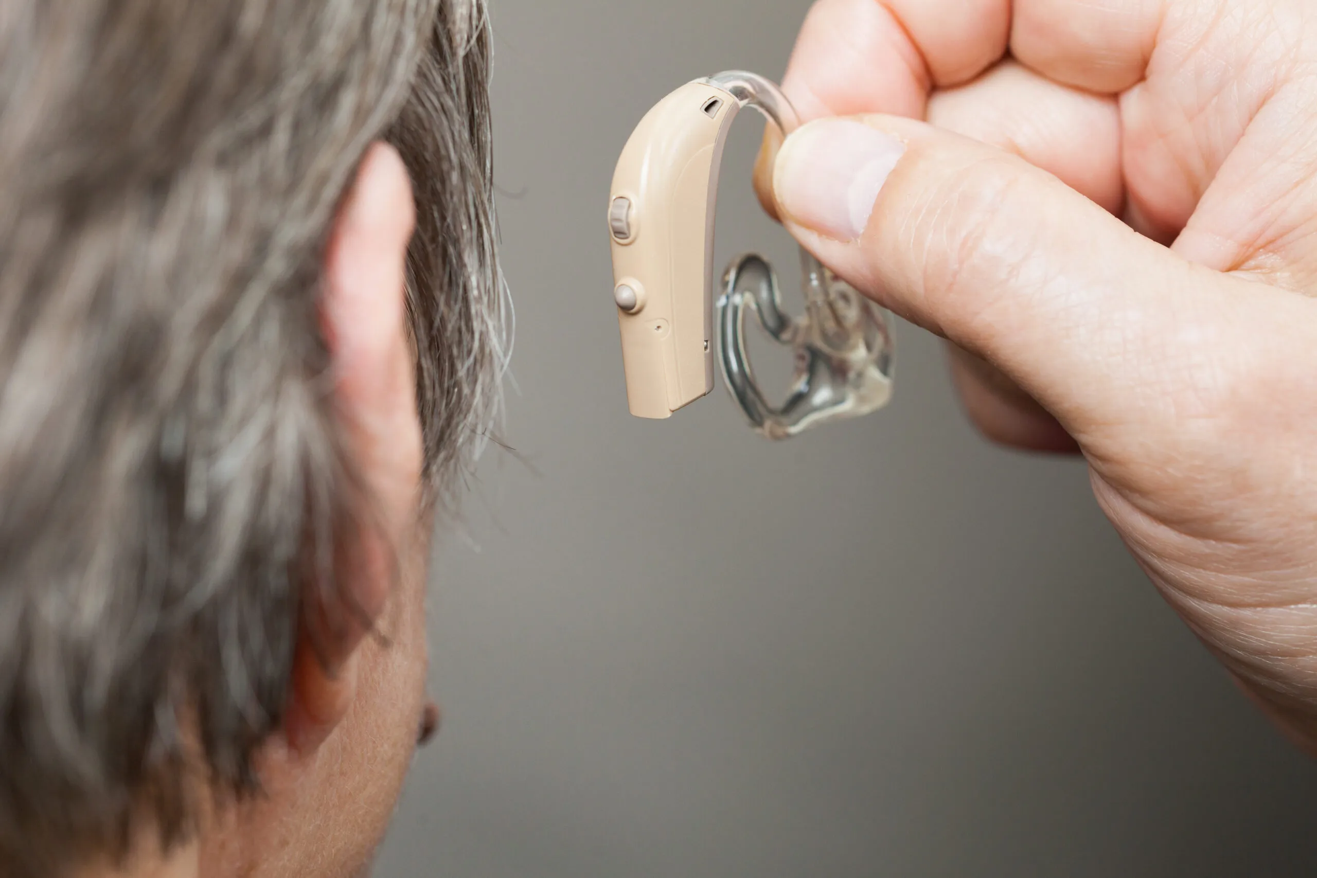 Doctor putting on the hearing aid