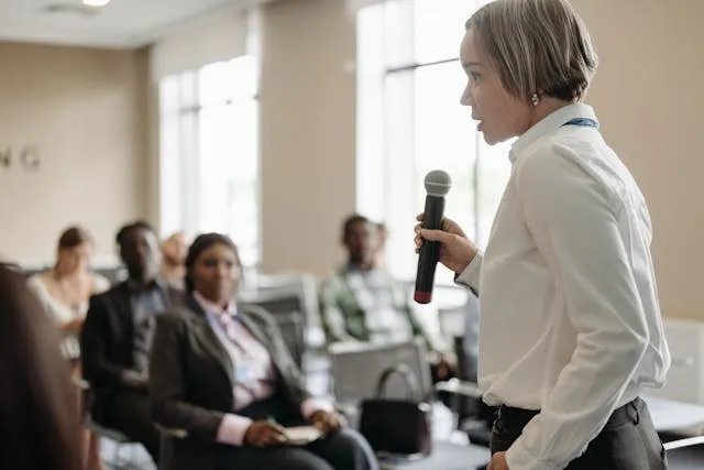 woman giving speech to crowd|