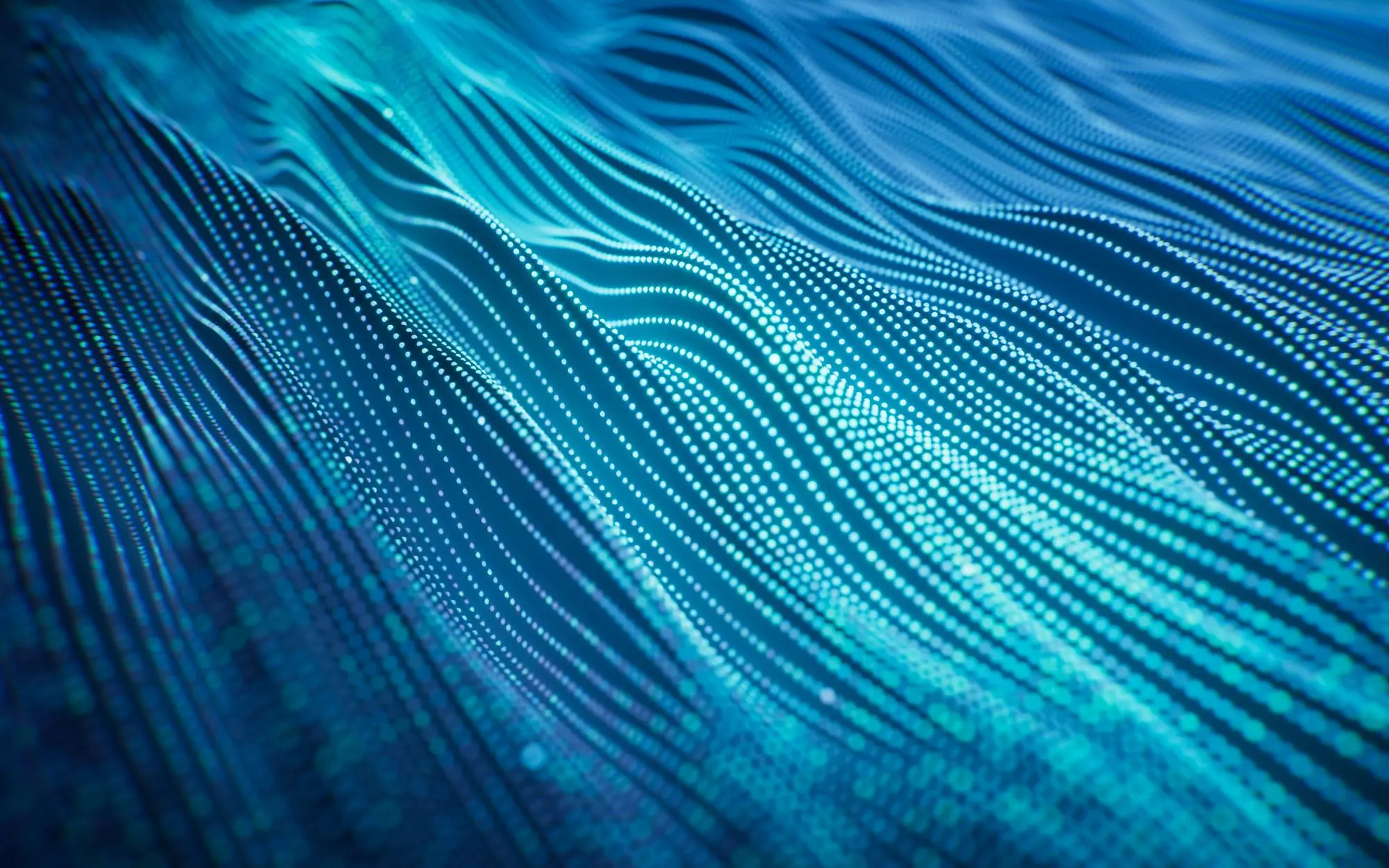 Abstract digital waves made of glowing blue dots forming fluid, wave-like patterns.