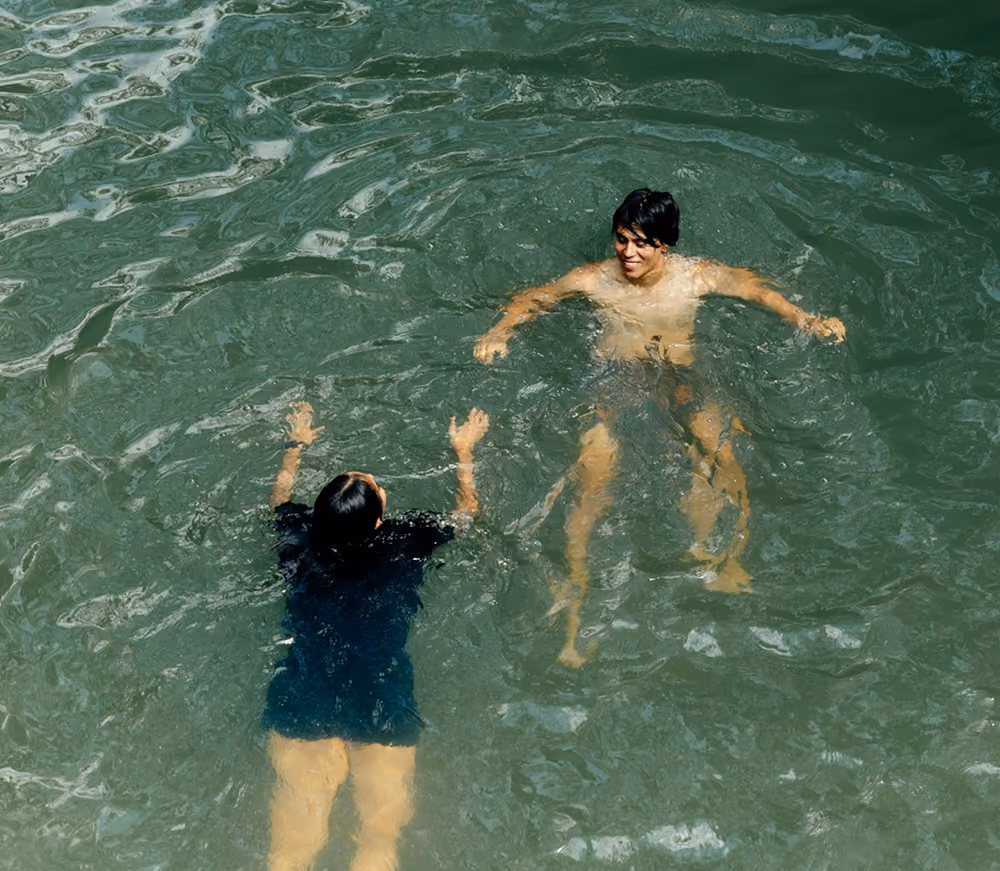 2 people swimming in ocean 