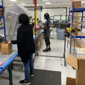 A photograph of employees using Pulsafeeder barriers