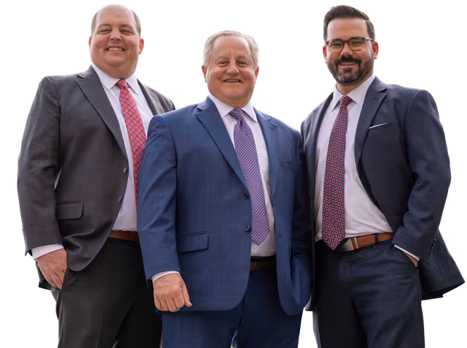 Three men in suits smiling, standing side by side, dressed in blue, gray, and black suits with ties.