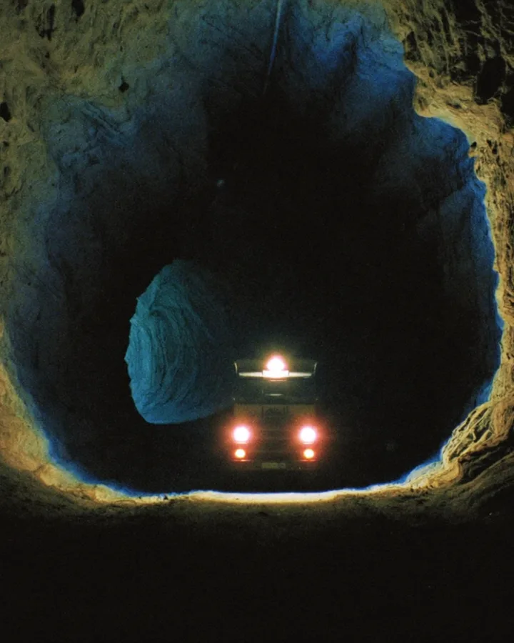 Headlights of a haul truck in an underground mine tunnel