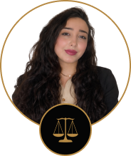 Professional headshot of a smiling woman with long, dark curly hair, framed in a gold circle badge with a small legal scales icon at the bottom.