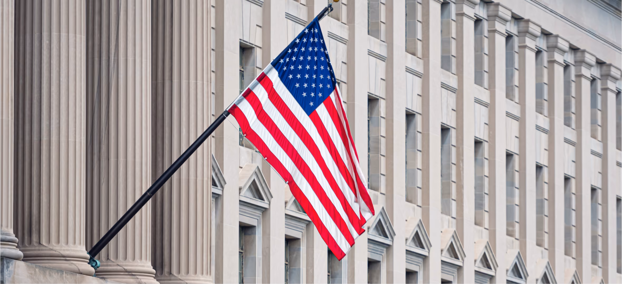 American flag outside government building representing federal government contracting and public sector service