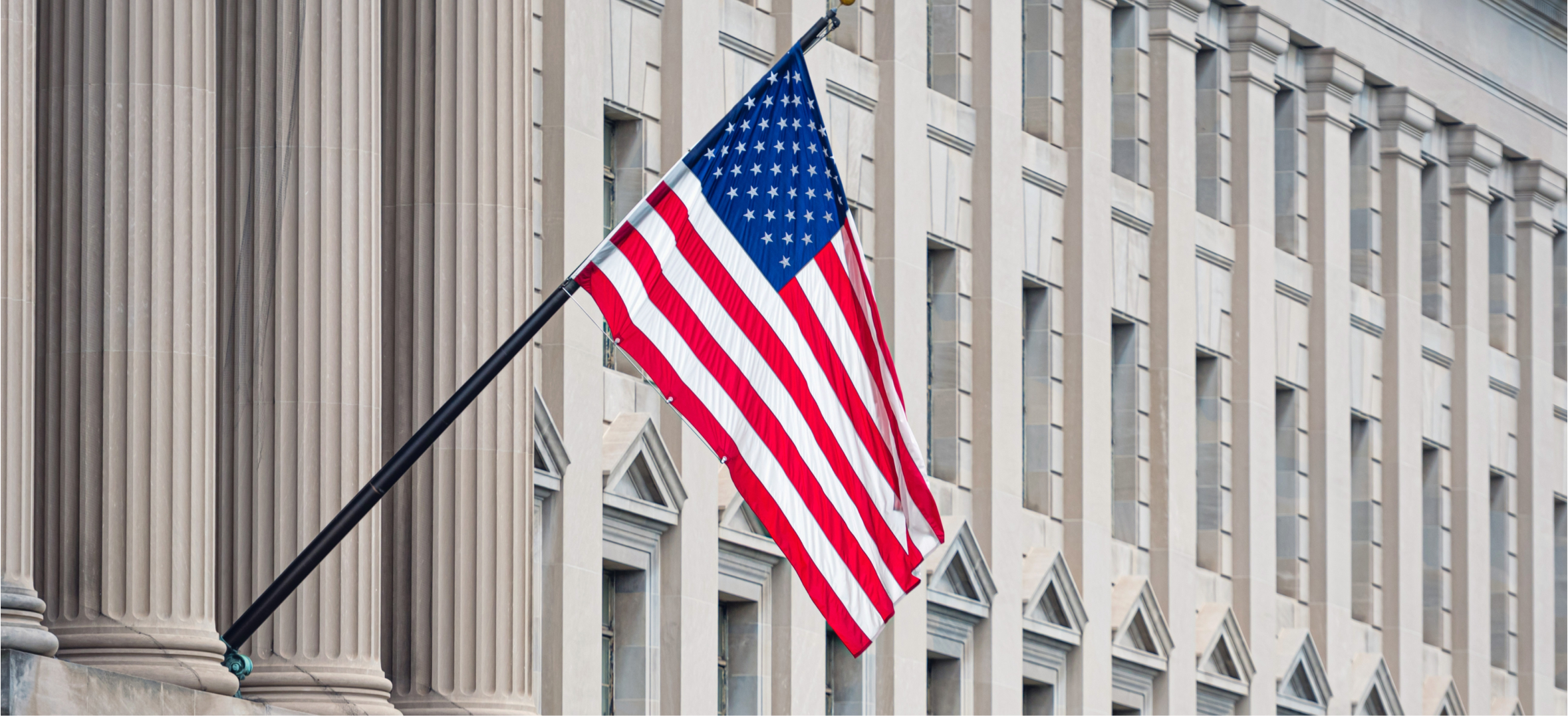American flag outside government building representing federal government contracting and public sector service