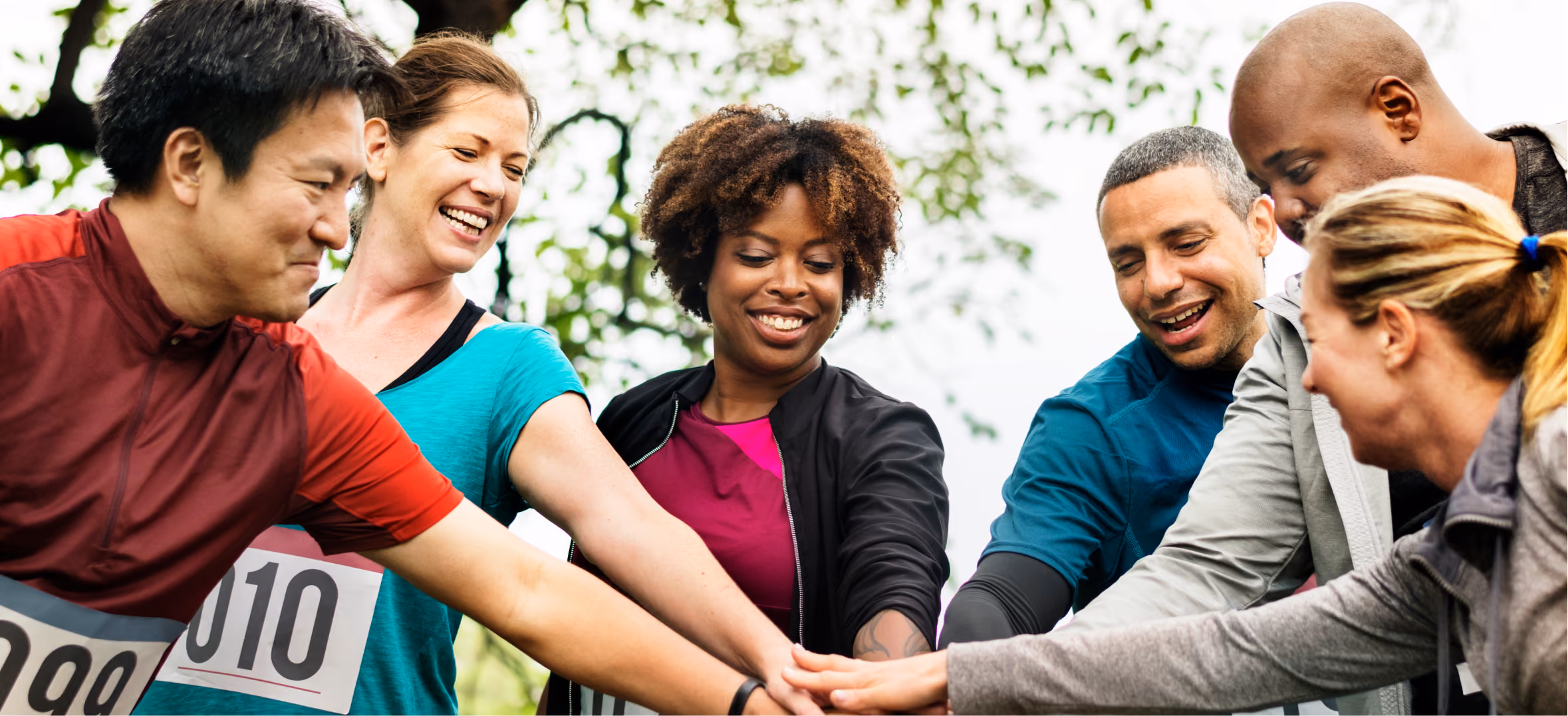 Diverse volunteers joining hands to support nonprofit initiatives, public interest and community engagement to