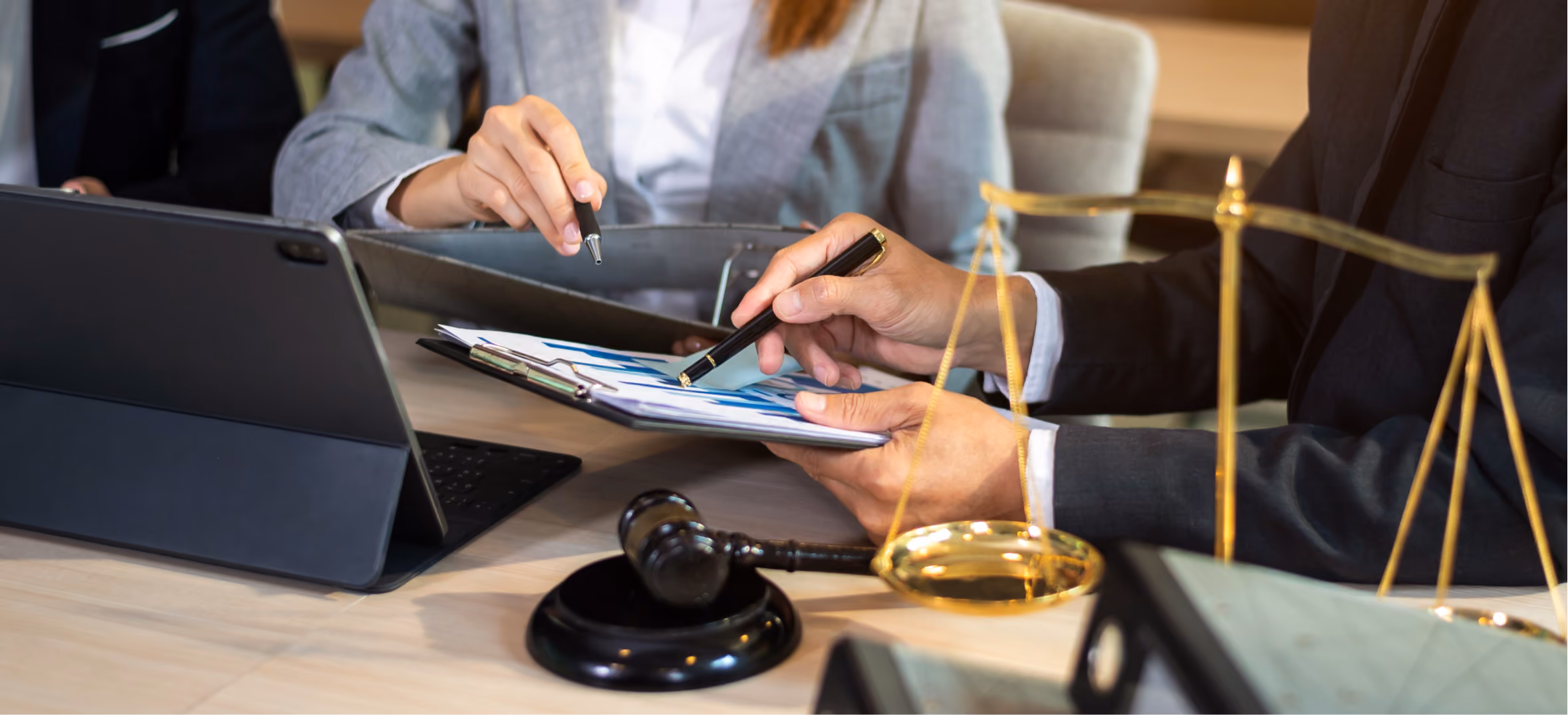 Attorneys with gavel and scales of justice, representing law and professional services firm presentation work.