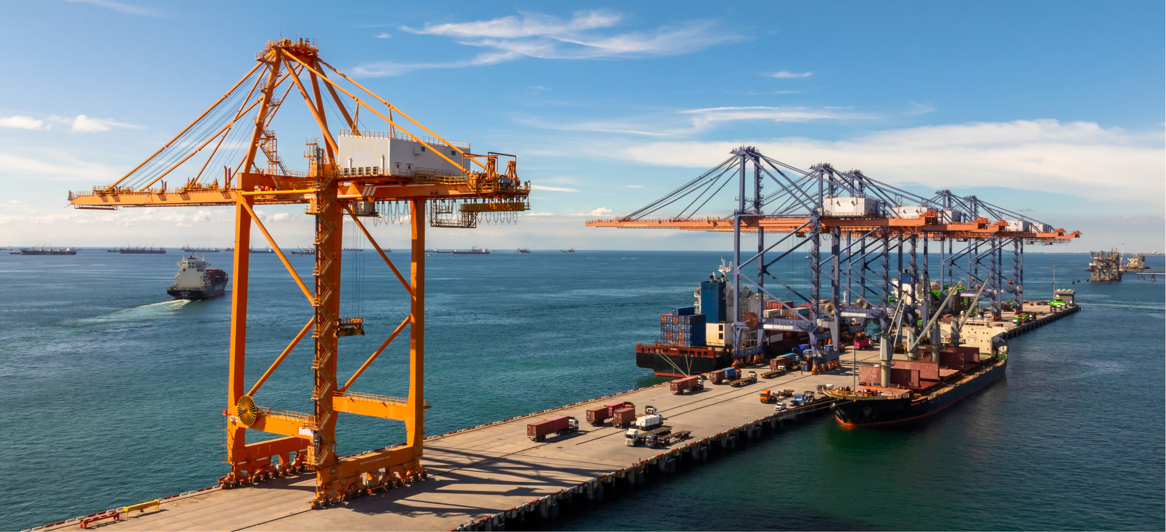 Cargo cranes loading container ships, representing port and logistics infrastructure presentation clients now.