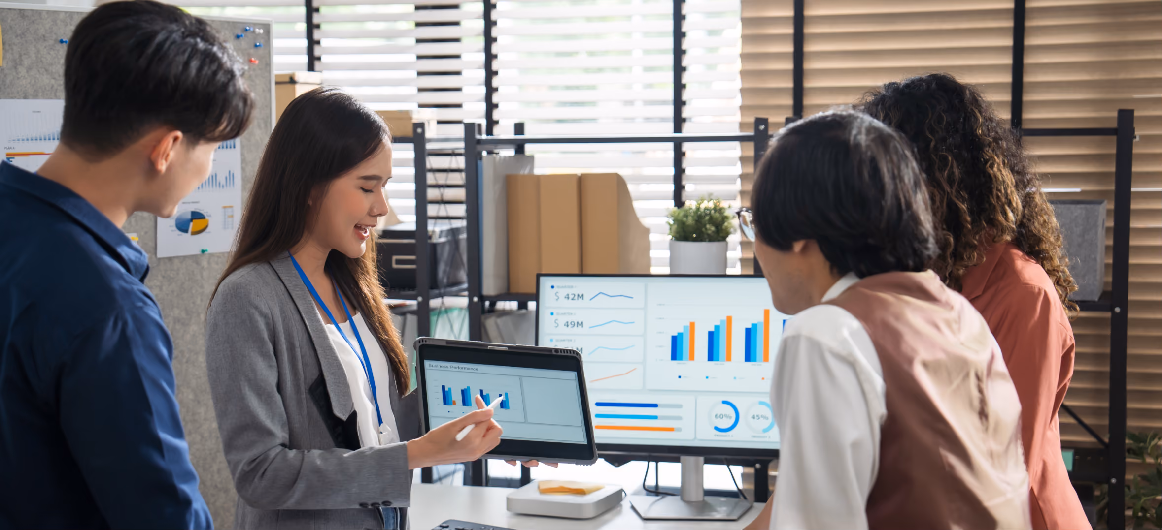 Businesswoman presenting revenue dashboard charts to team, representing high-growth SaaS and B2B technology