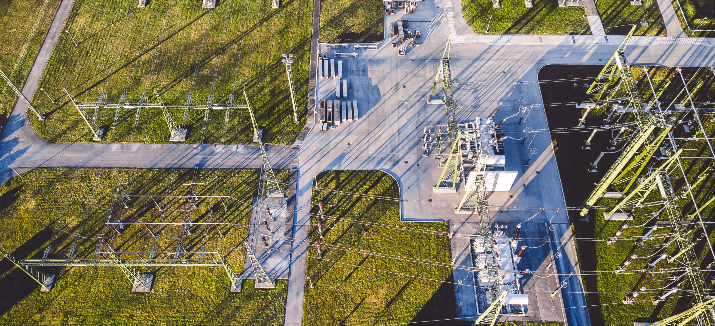 Aerial view of electrical substation with power lines, representing energy technology and grid modernization