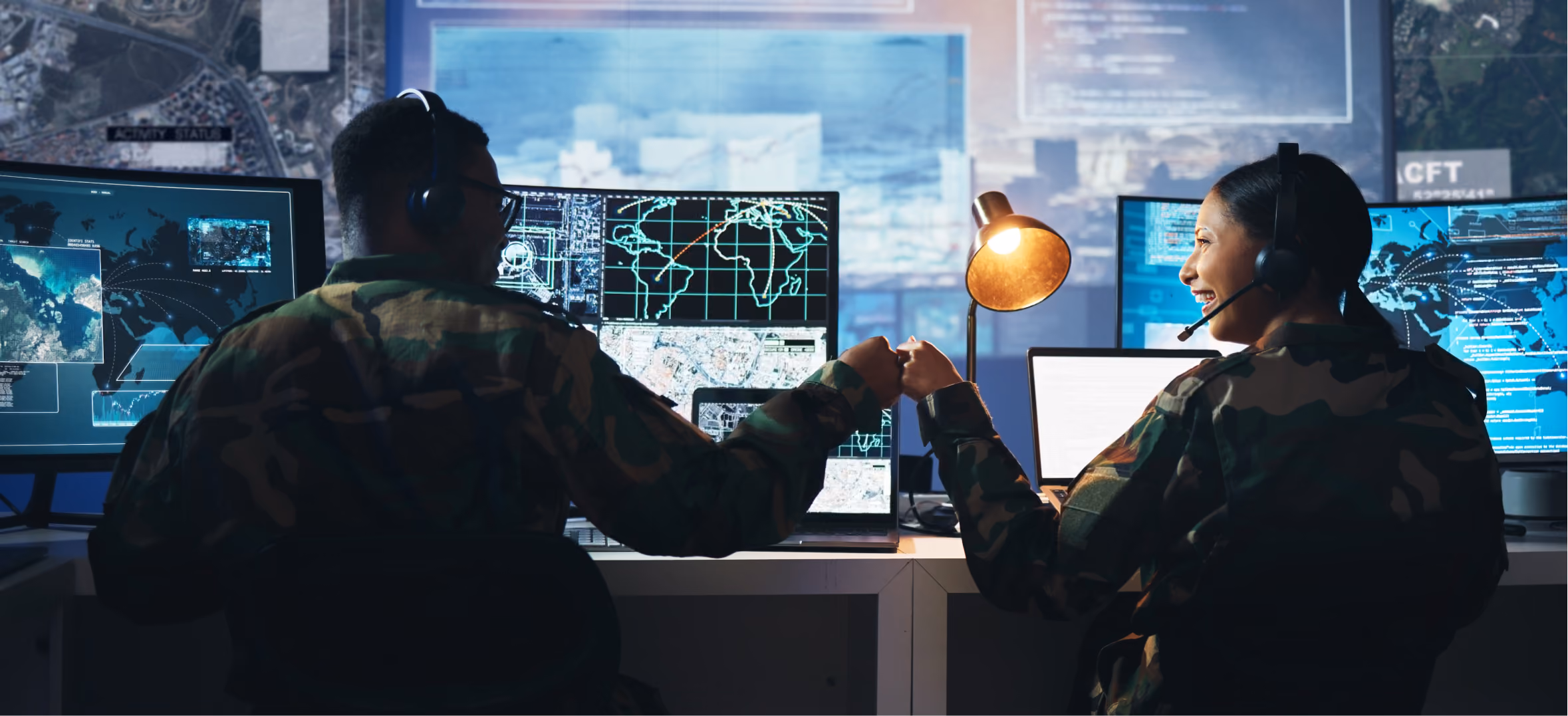 Military analysts monitor global operations with digital maps and communication systems in command center toge