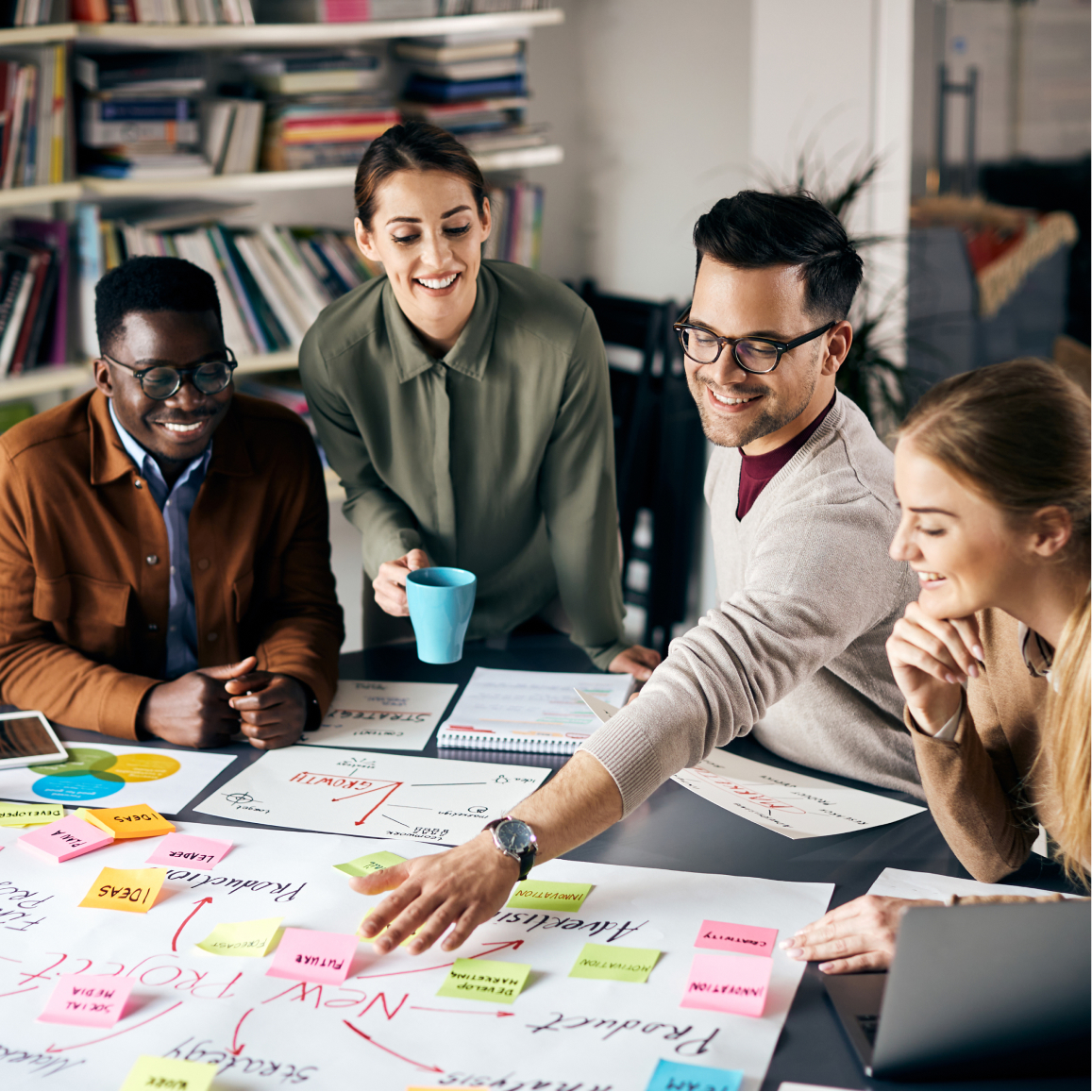 Team collaborating on cybersecurity strategy planning with notes charts and presentation materials on desk....