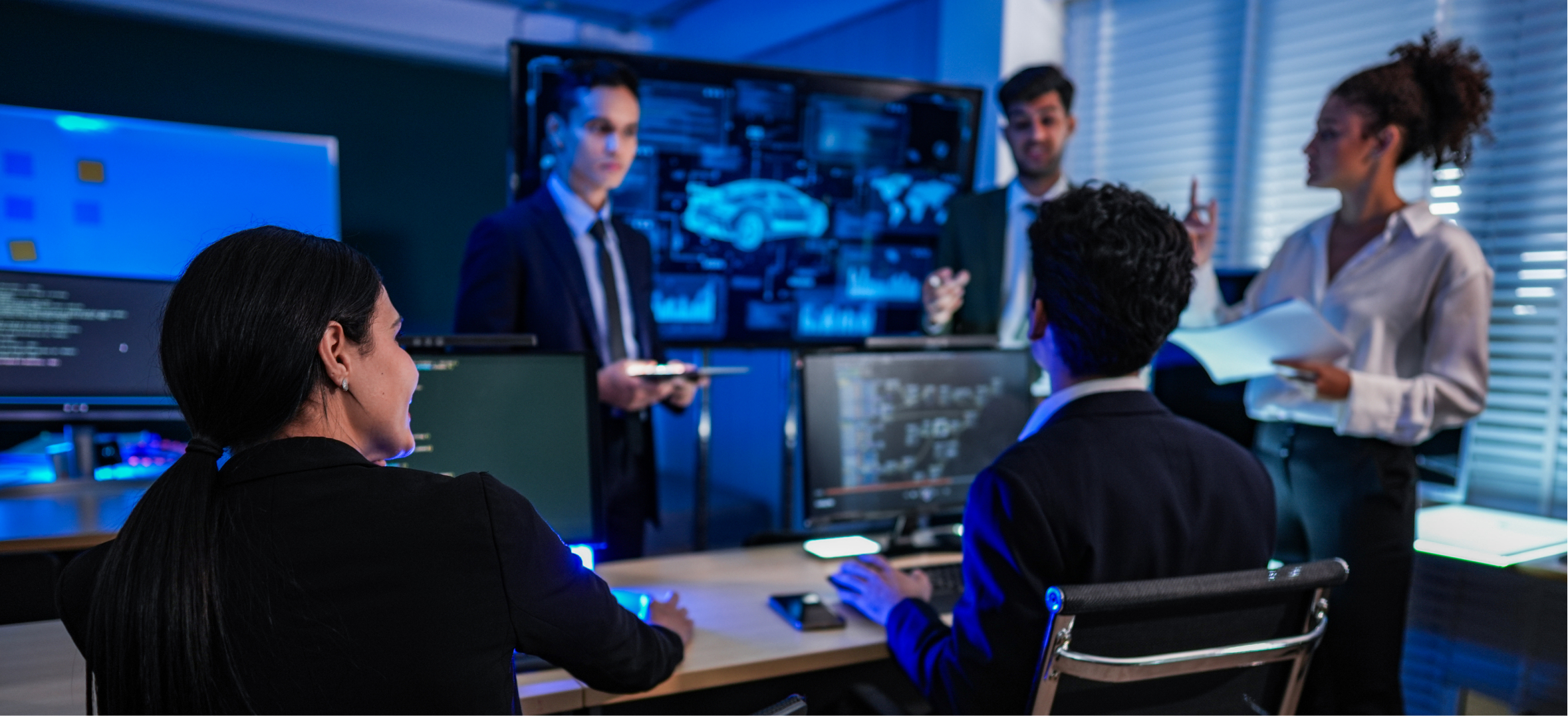 Security leaders presenting cybersecurity strategy to investors with technical dashboards and team discussion.