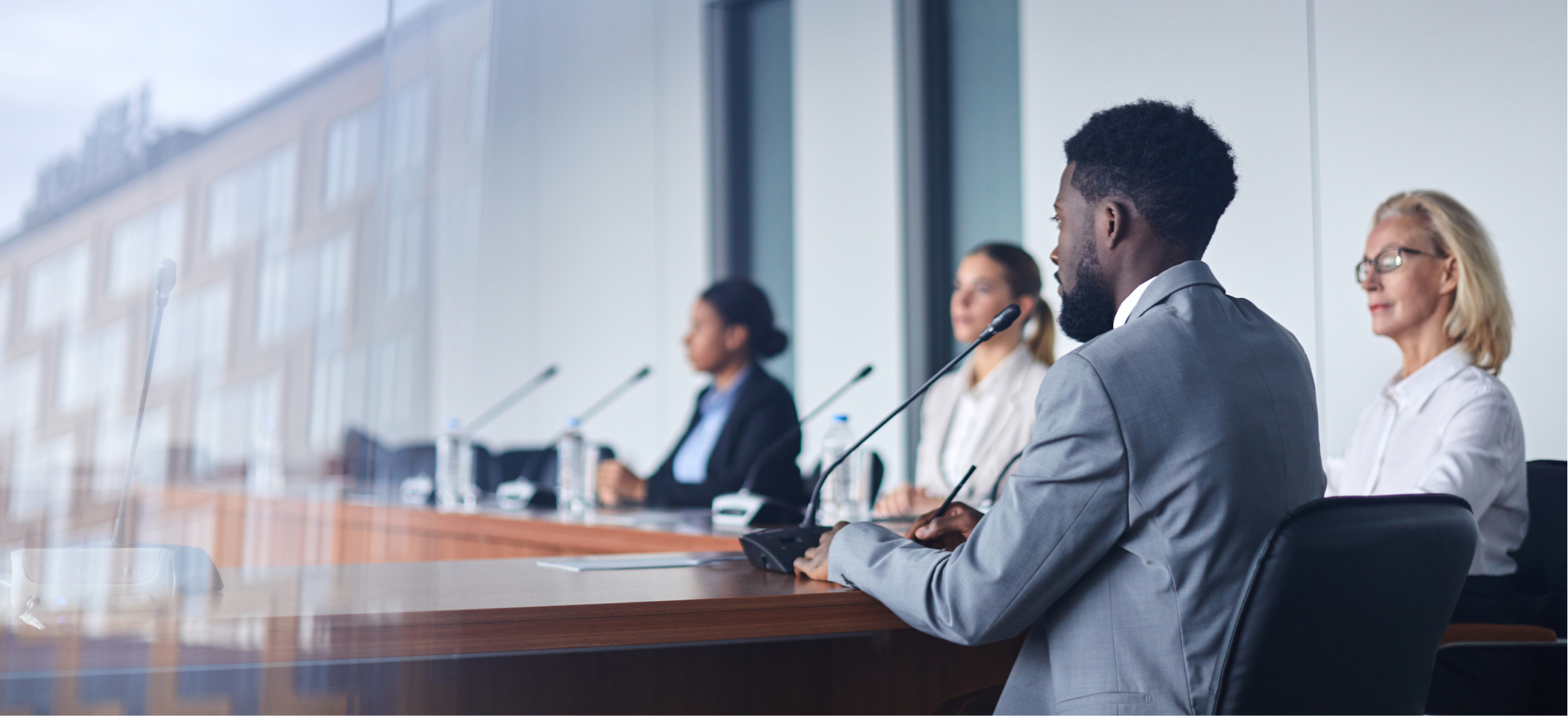 Government style cybersecurity briefing with panel members discussing security policies and compliance strateg