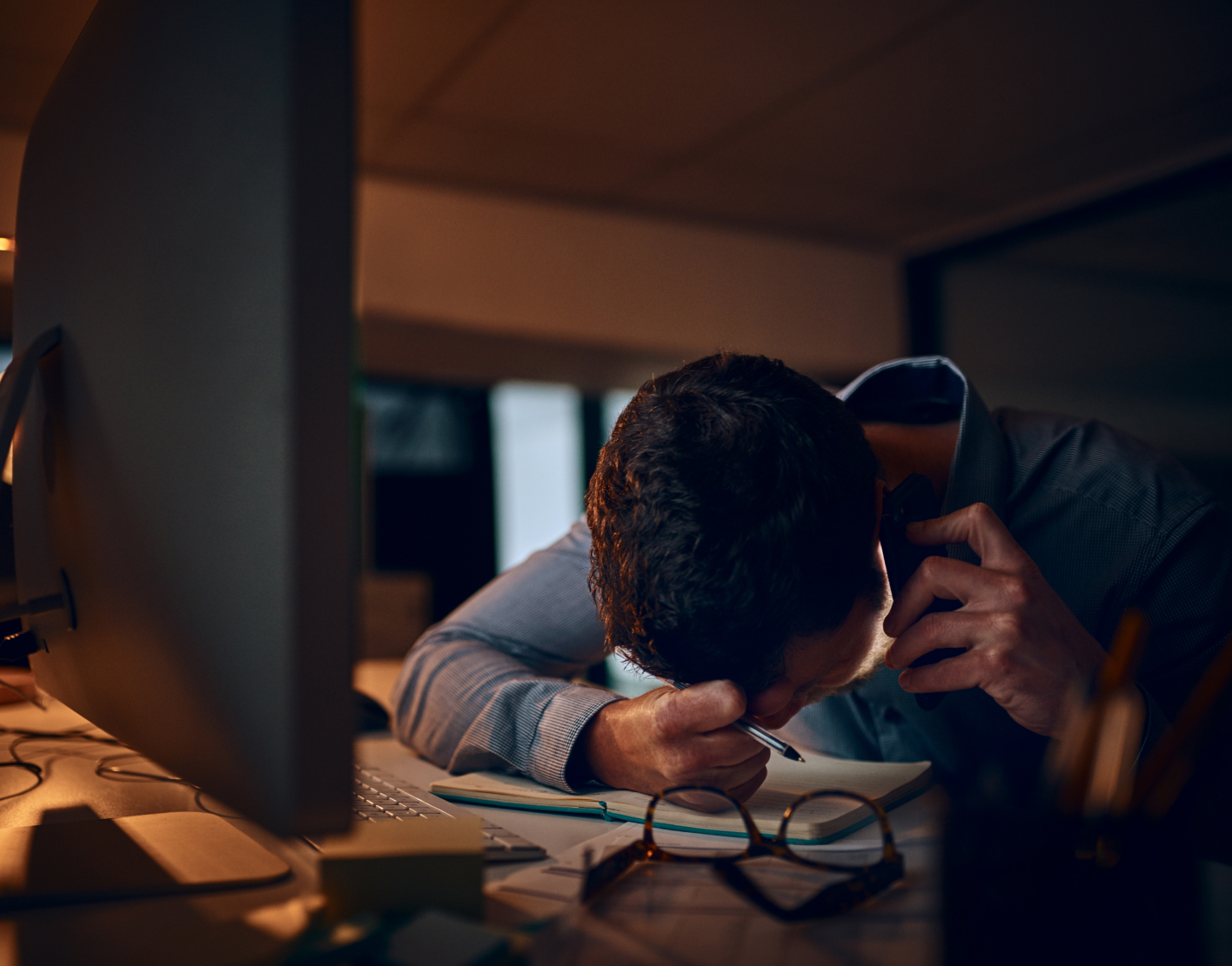 Professional experiencing presentation fatigue while reviewing cybersecurity reports and business documents...