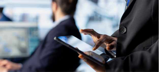 Financial services professional using a tablet to review business data for a fintech presentation in Singapore