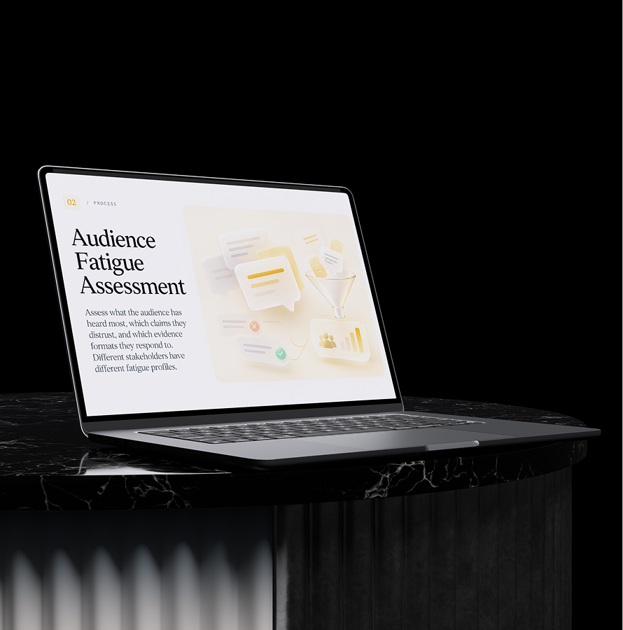 Laptop on a dark stand showing an Audience Fatigue Assessment slide for cybersecurity presentations