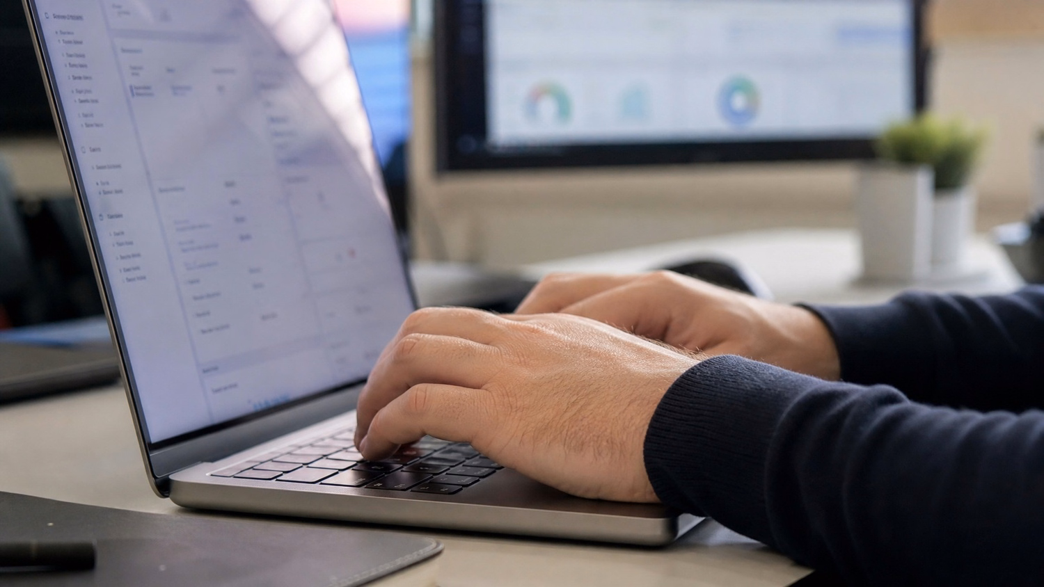 Fingers typing on laptop, adding product descriptions 59