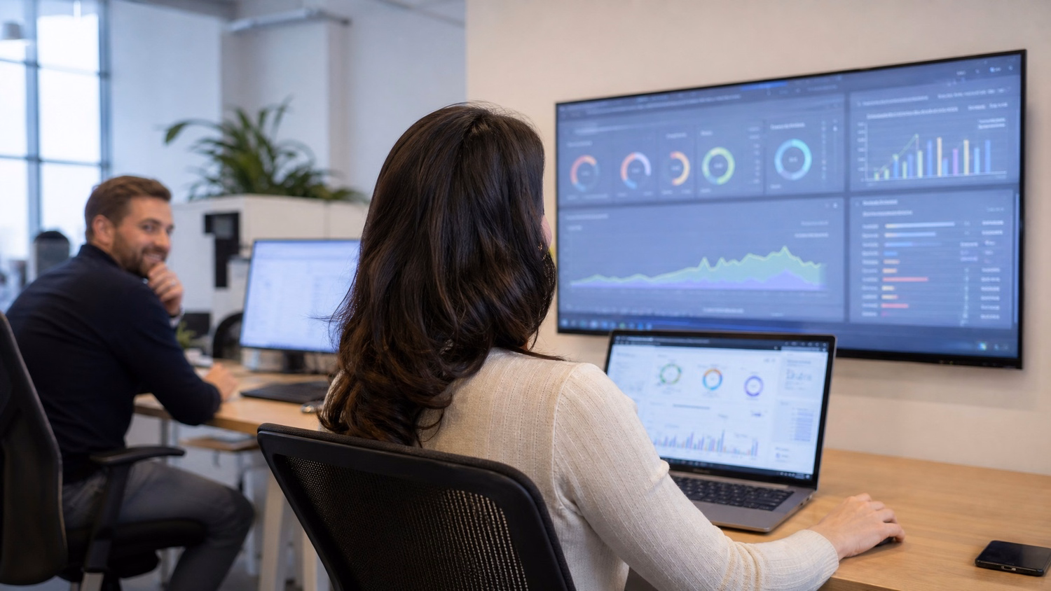 Woman reviews AI readiness dashboard on wall monitor 58 chars