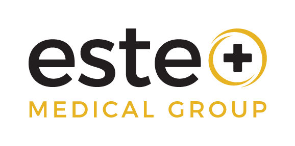 Logo for Este Medical Group with the word 'este' in black lowercase letters, followed by a gold circle enclosing a black medical cross, and 'MEDICAL GROUP' in gold uppercase letters beneath.