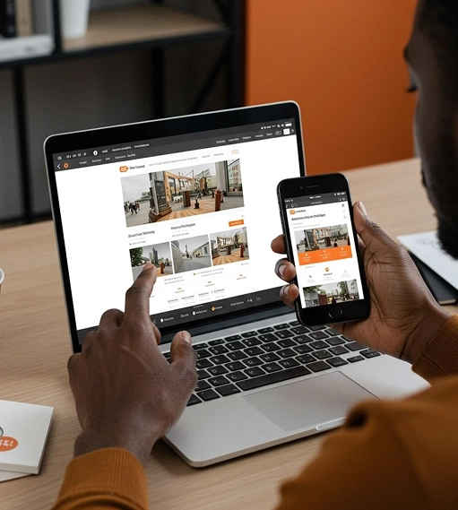 Person browsing a real estate website on both a laptop and a smartphone, viewing property listings with photos and descriptions.