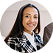Smiling woman with long dark hair wearing a black and white plaid jacket and a black top.