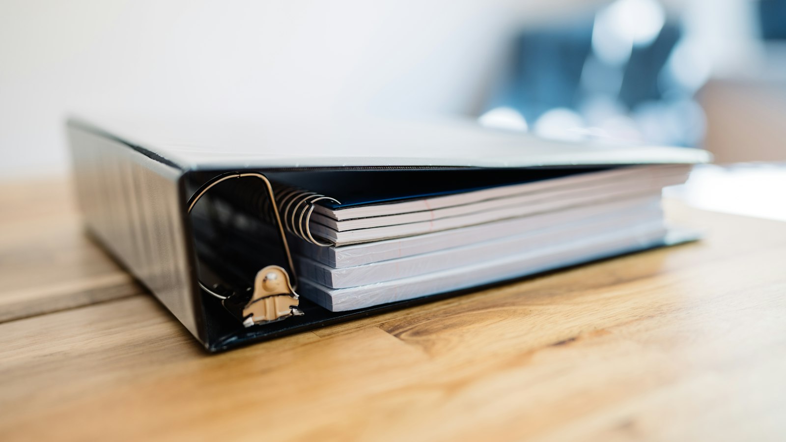 Classeur de documents sur un bureau en bois : le licenciement pour insuffisance professionnelle dans un OGEC